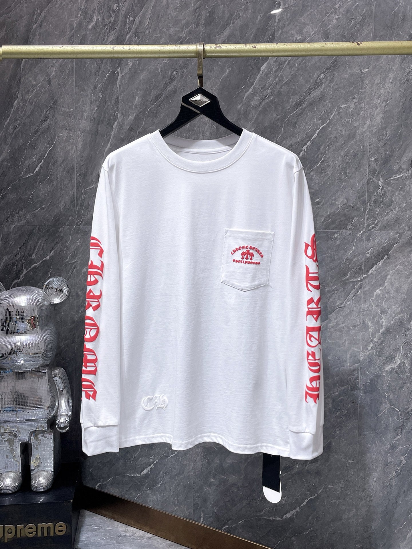 a Chrome Hearts Hollywood Triple Cross Long Sleeve T-Shirt featuring a prominent graphic on the back.