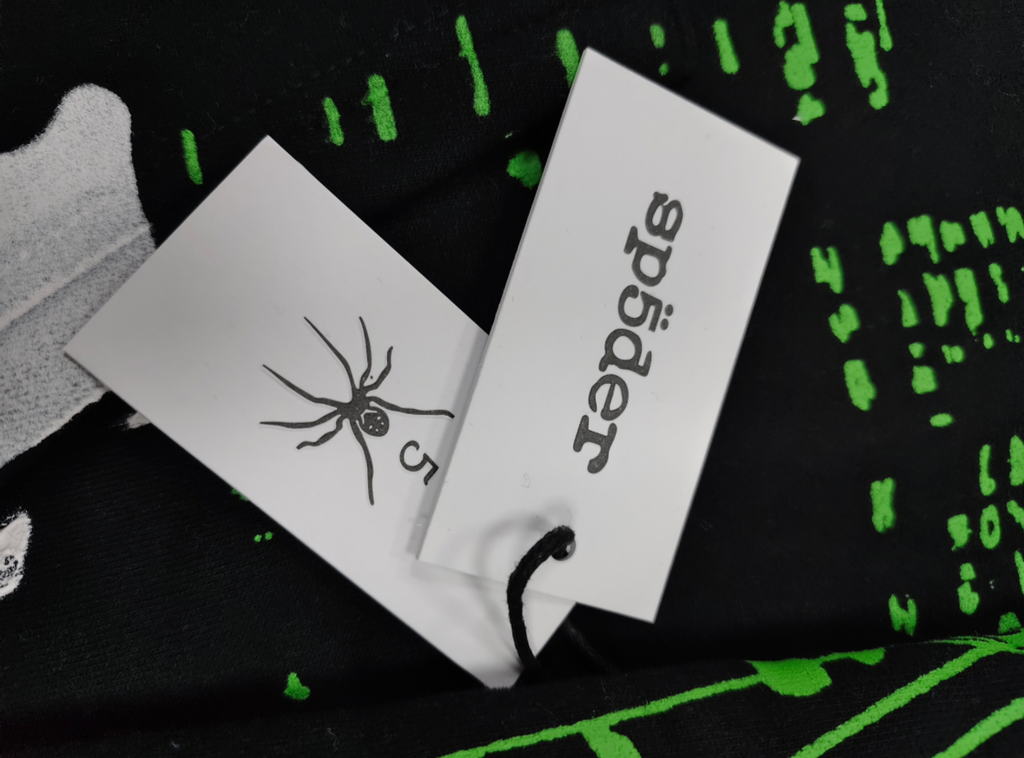 black Sp5der X-Ray Hoodie featuring prominent neon green slime-style graphics