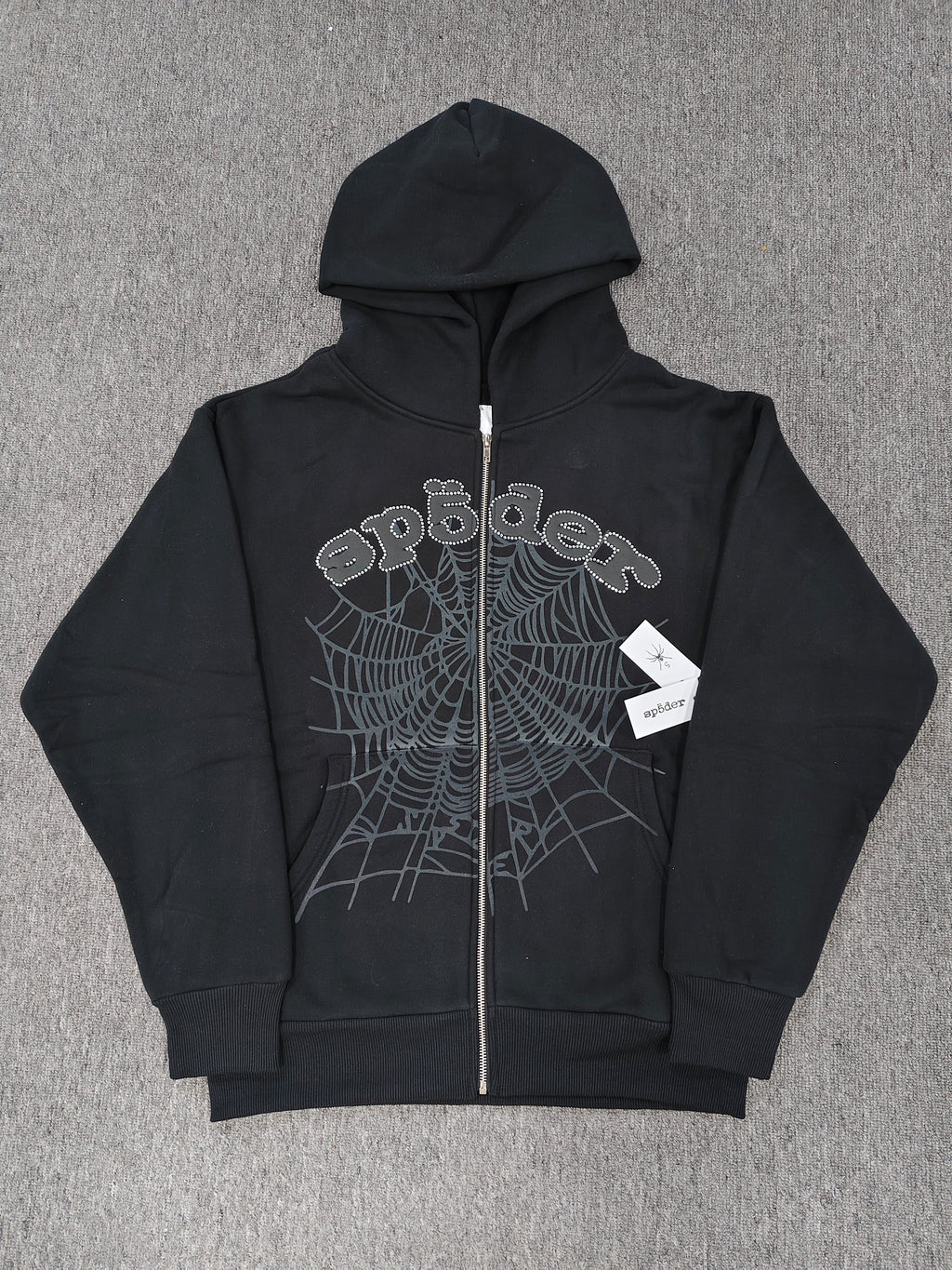 black Sp5der OG Web V2 Phantom Zip Up Hoodie features a prominent rhinestone-embellished logo and web graphic