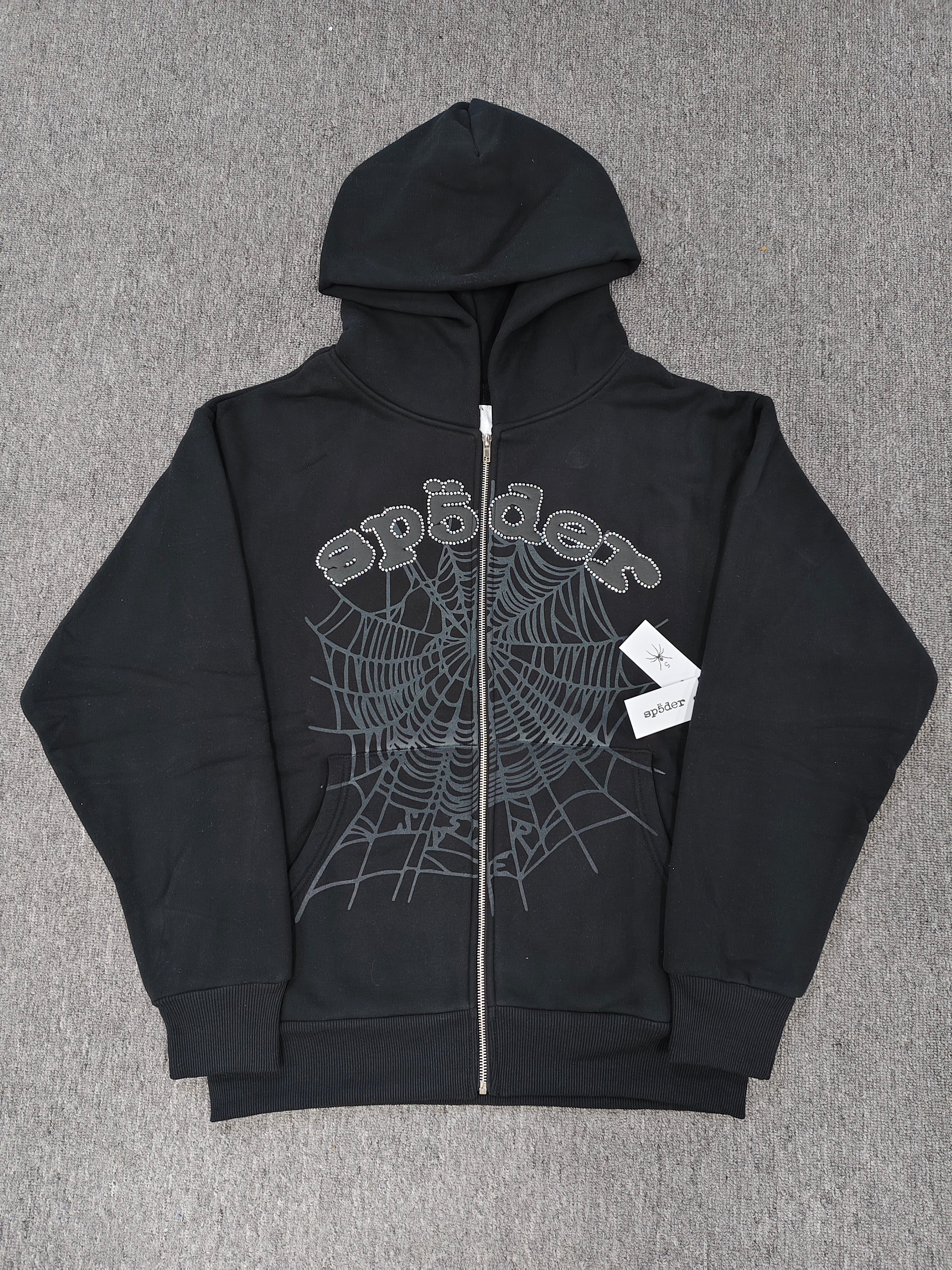 black Sp5der OG Web V2 Phantom Zip Up Hoodie features a prominent rhinestone-embellished logo and web graphic