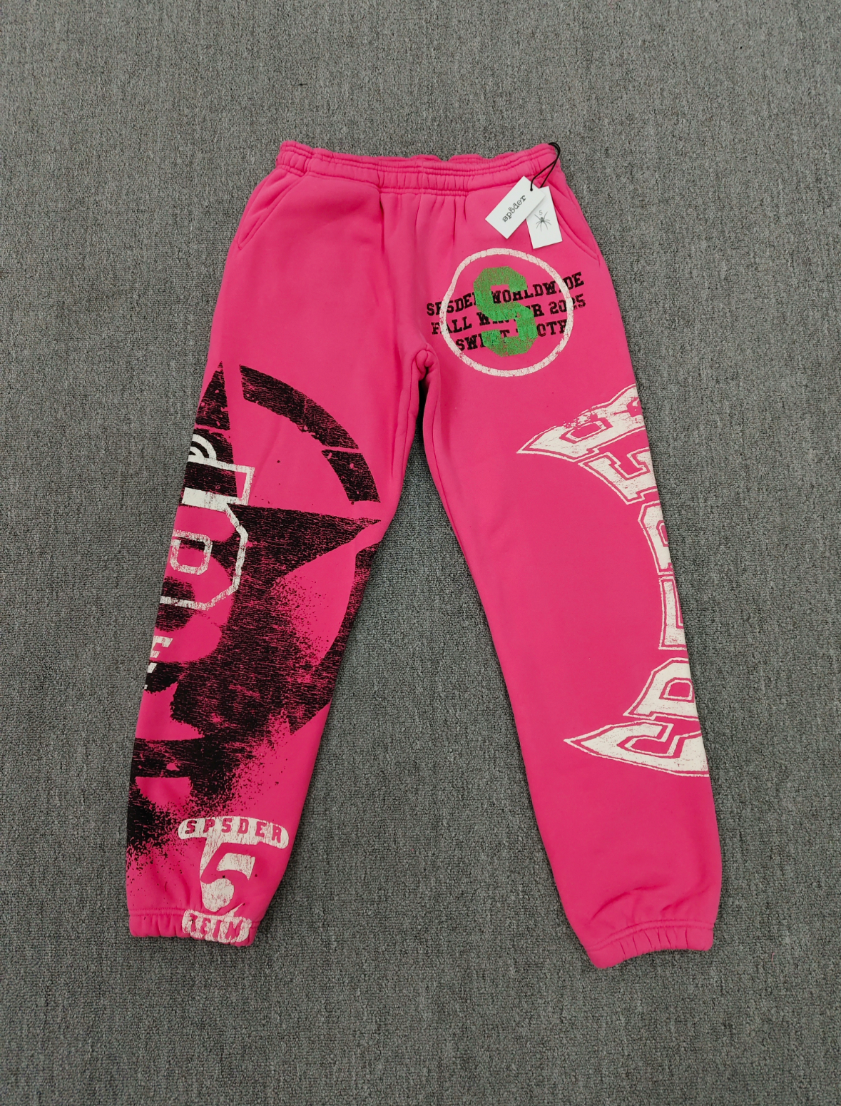 SP5DER Stencil Sweatpants in pink, featuring a large black star graphic on the left leg