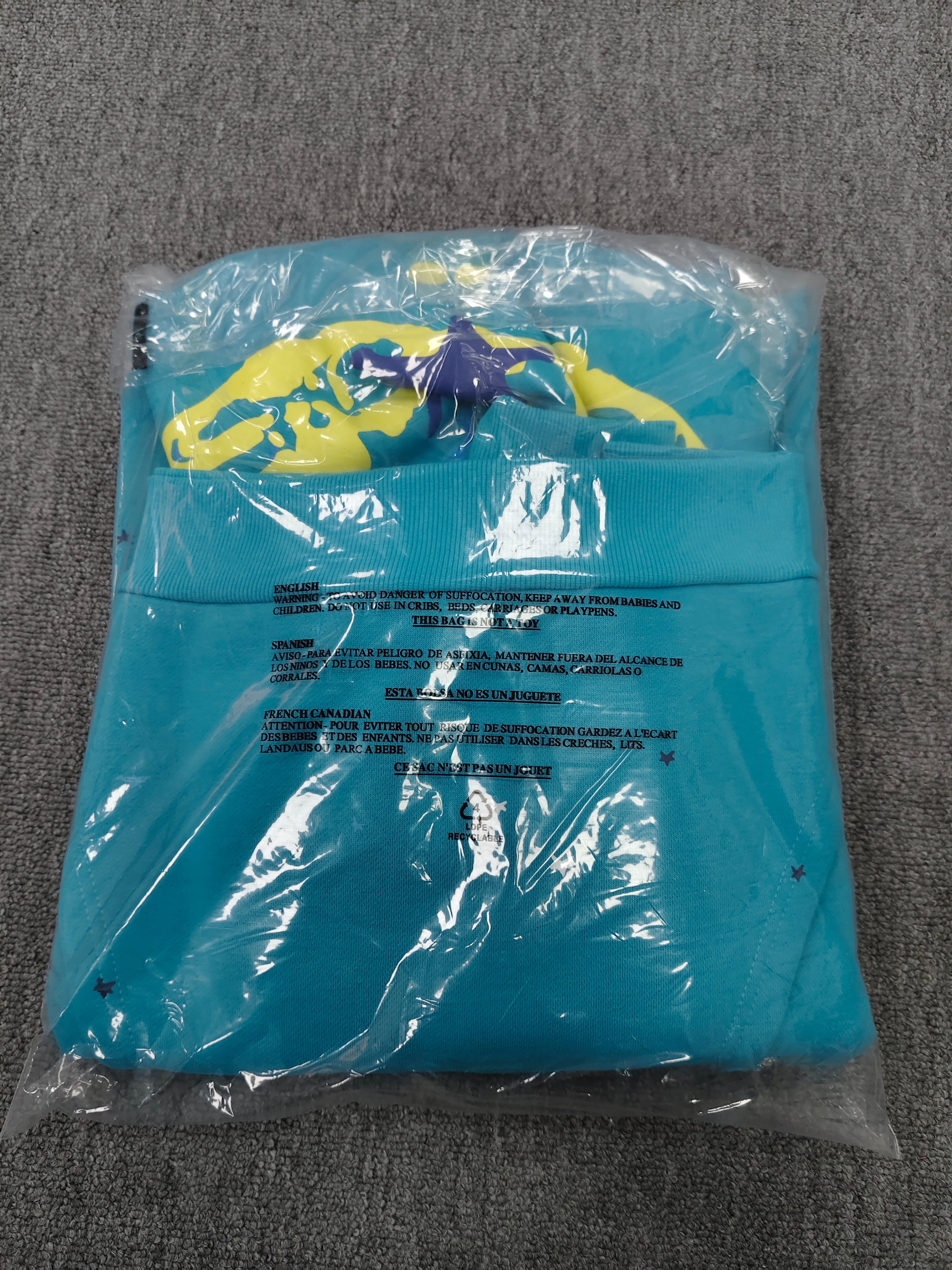 Sp5der Heavy Web Hoodie in 'Cyan' is designed with a striking blue color and a signature web-inspired graphic on the hood