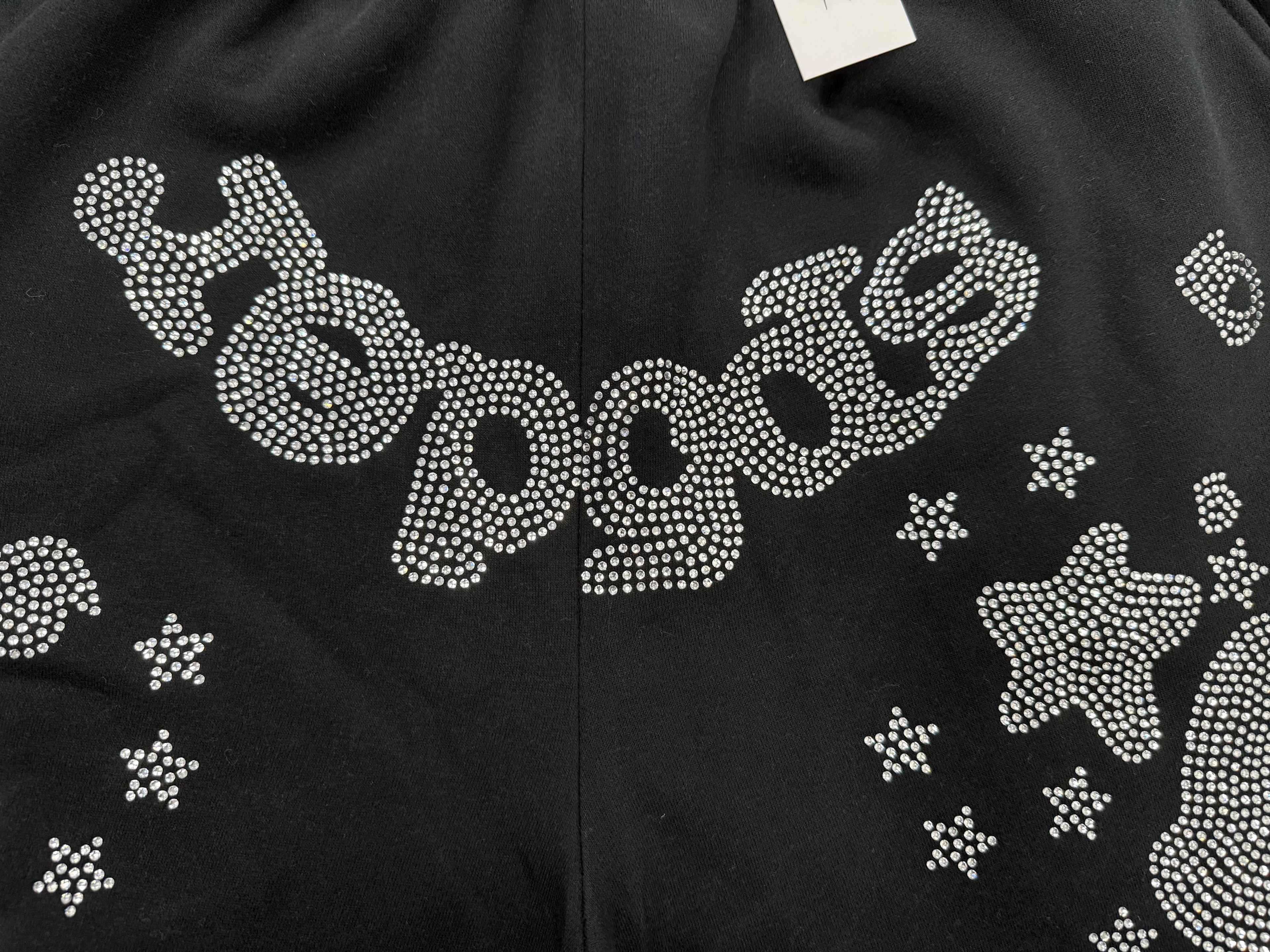 Sp5der Black Rhinestone Letter Print Jogger Shorts featuring a distinctive rhinestone star graphic.