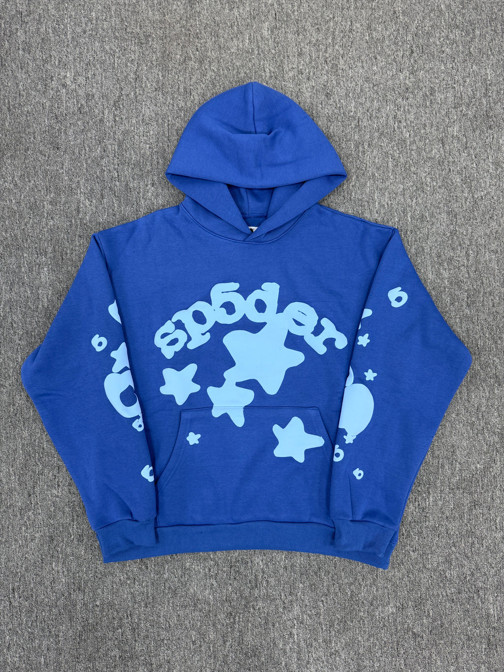blue Sp5der Beluga hoodie features a distinct light blue graphic print of stars and the brand name on the front and sleeves