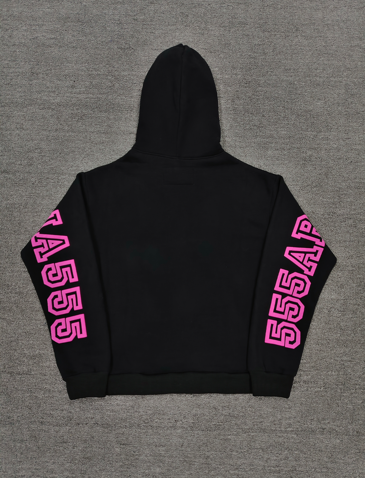 a black Sp5der Arachnophobia hoodie with vibrant pink lettering