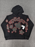 a black Sp5der Beluga Outline Hoodie featuring red-outlined star graphics