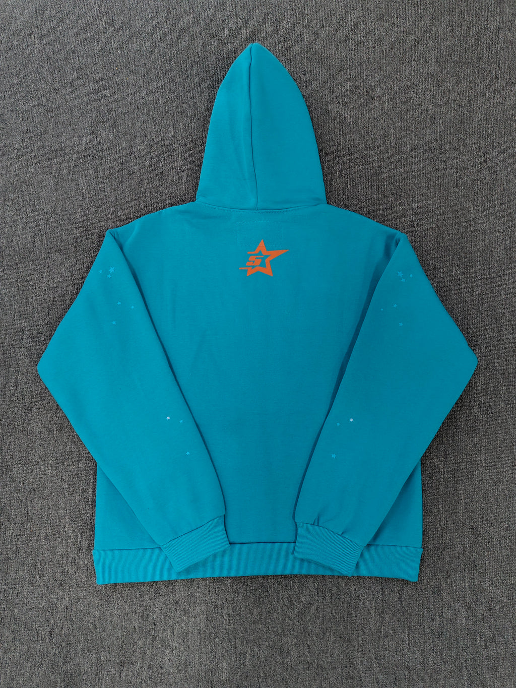a Sp5der Punk V2 Hoodie in the Cyan colorway, featuring a prominent rhinestone graphic and spider web motif