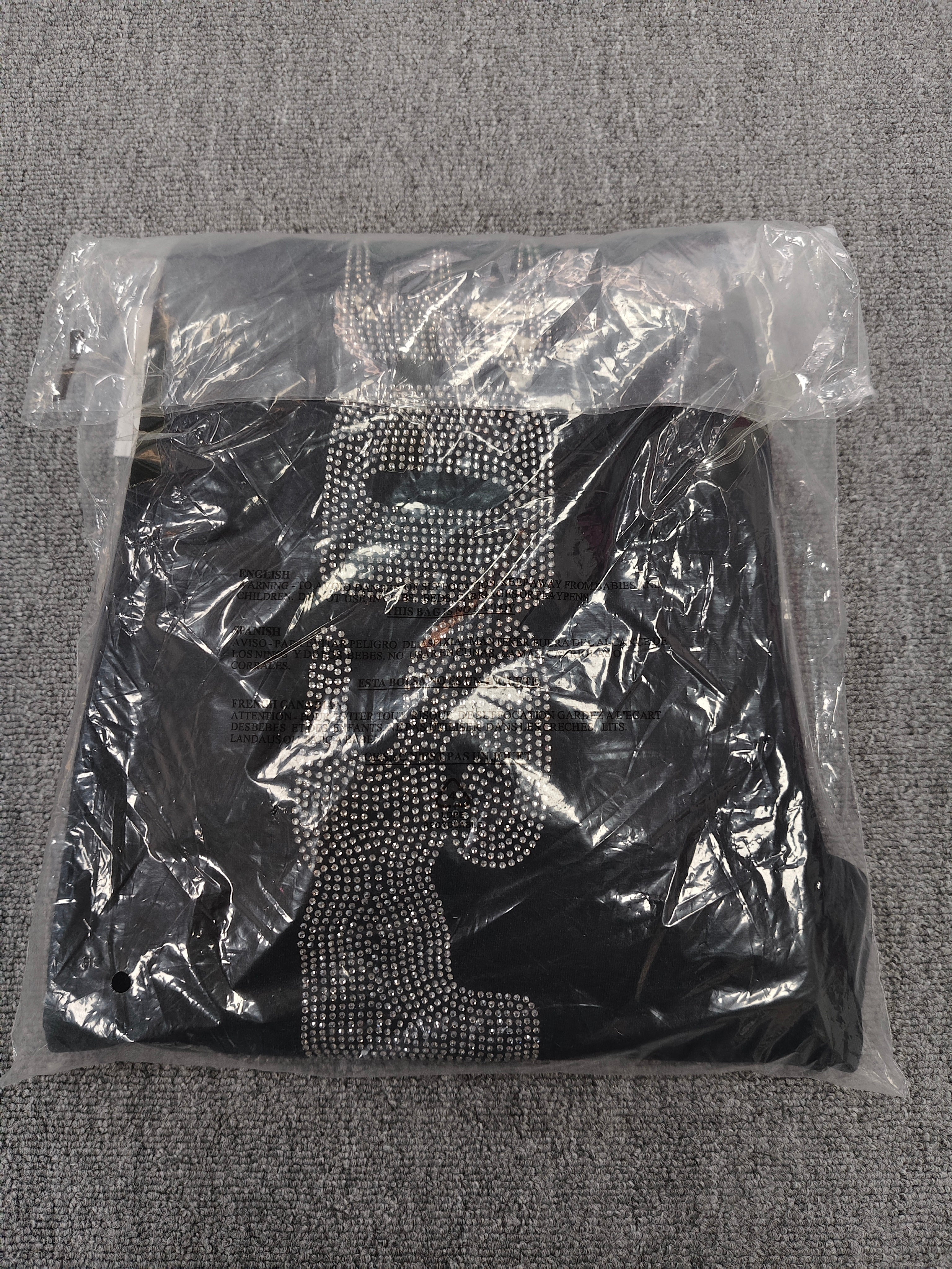 Sp5der Rhinestone Silk sweatpants in black featuring a large rhinestone-embellished logo and scattered star details