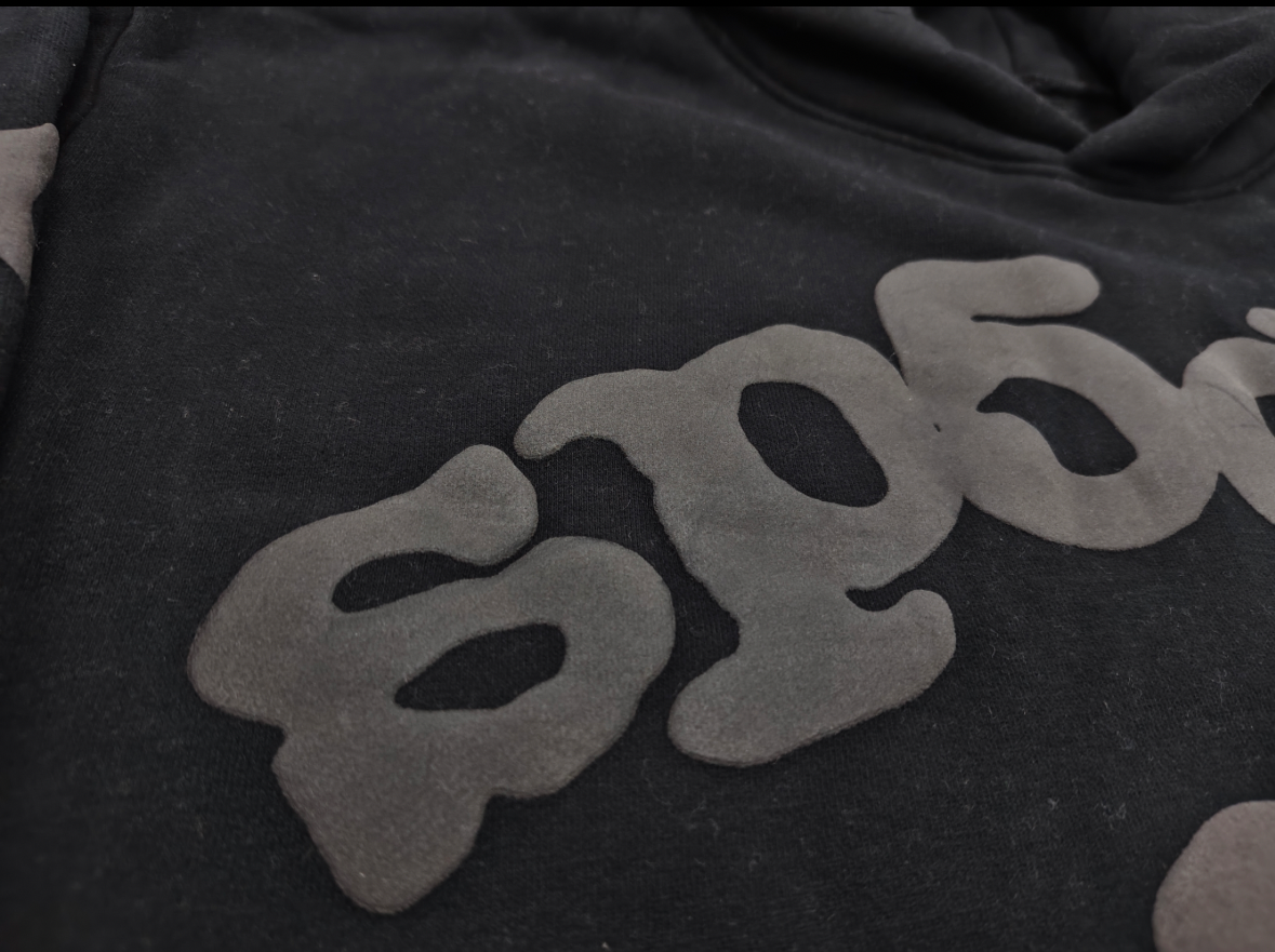 a Sp5der Reflective Beluga Hoodie in Black, featuring large reflective graphics