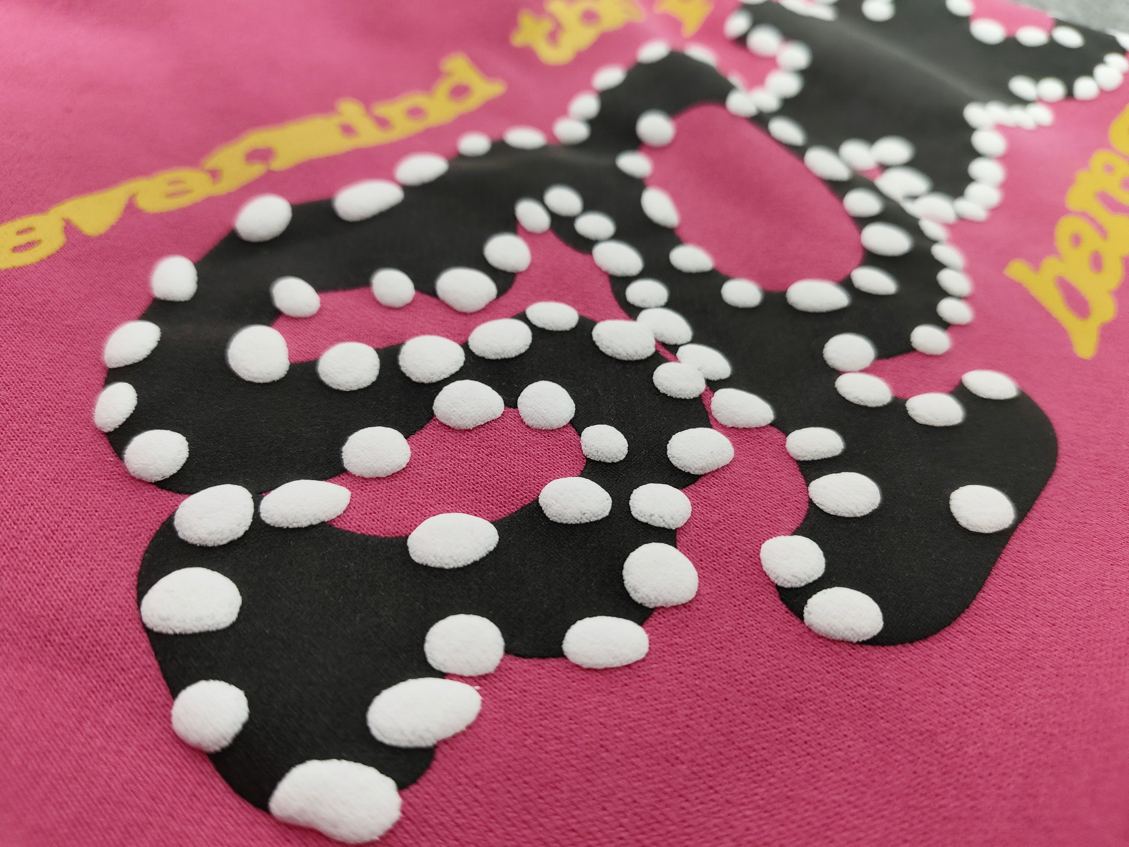 pink shorts Sp5der "Punk V2" collection, featuring rhinestone branding and scattered star graphics