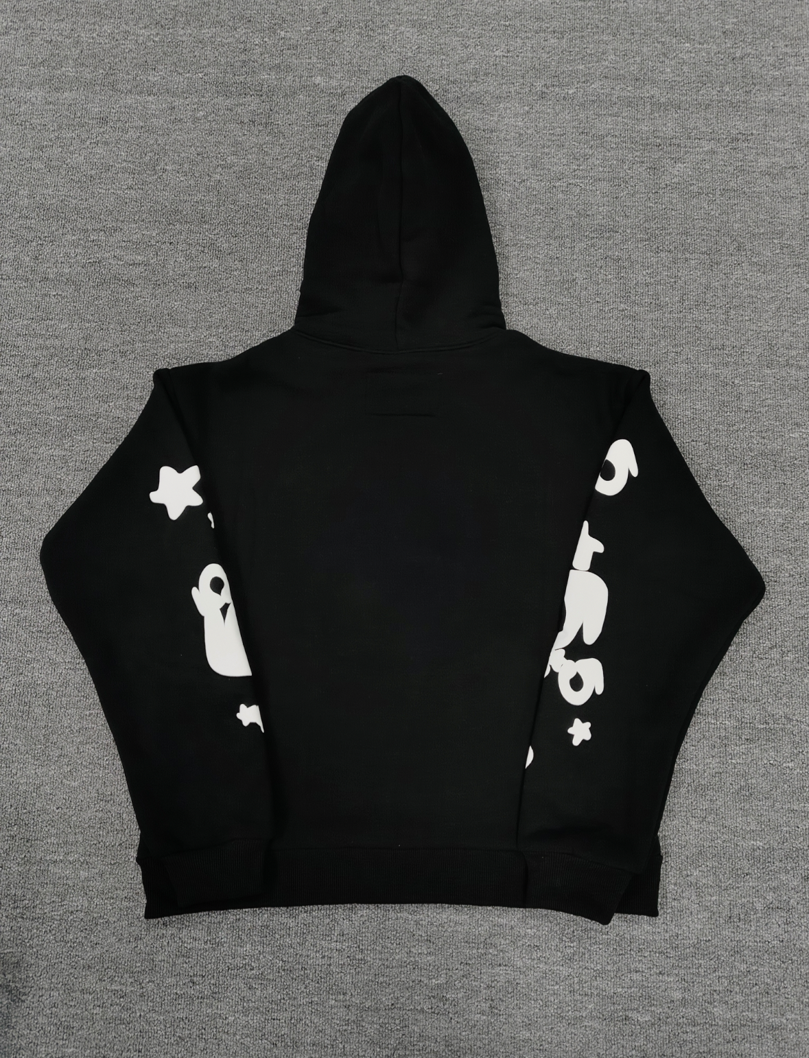 black Sp5der hoodie features reflective white graphic prints of the brand name and stars