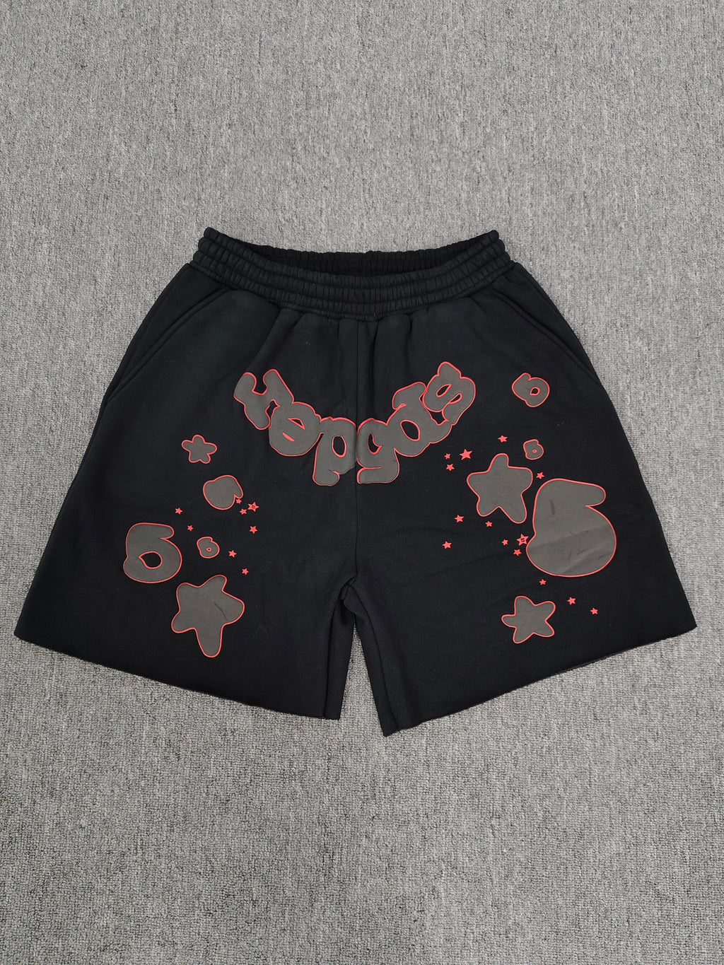 Sp5der Beluga Outline Sweatshorts in black, featuring prominent red-outlined graphic logos and stars