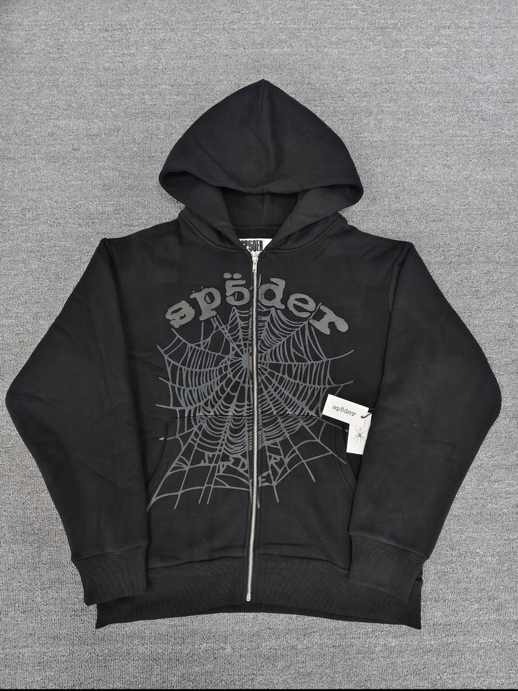 Sp5der OG Web V2 Phantom Zip Up hoodie features a black colorway with a prominent puff-printed web graphic on the front