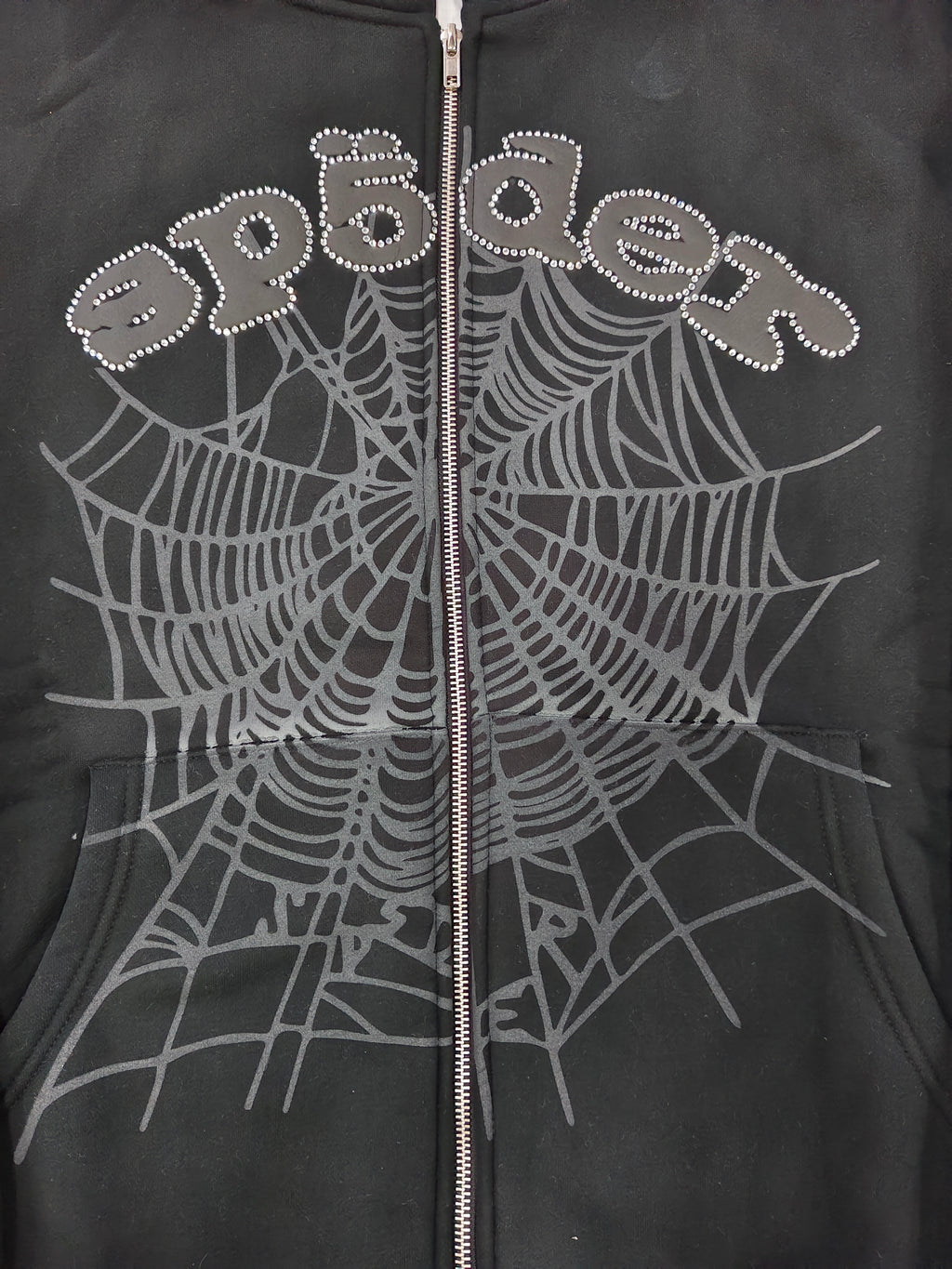 black Sp5der OG Web V2 Phantom Zip Up Hoodie features a prominent rhinestone-embellished logo and web graphic