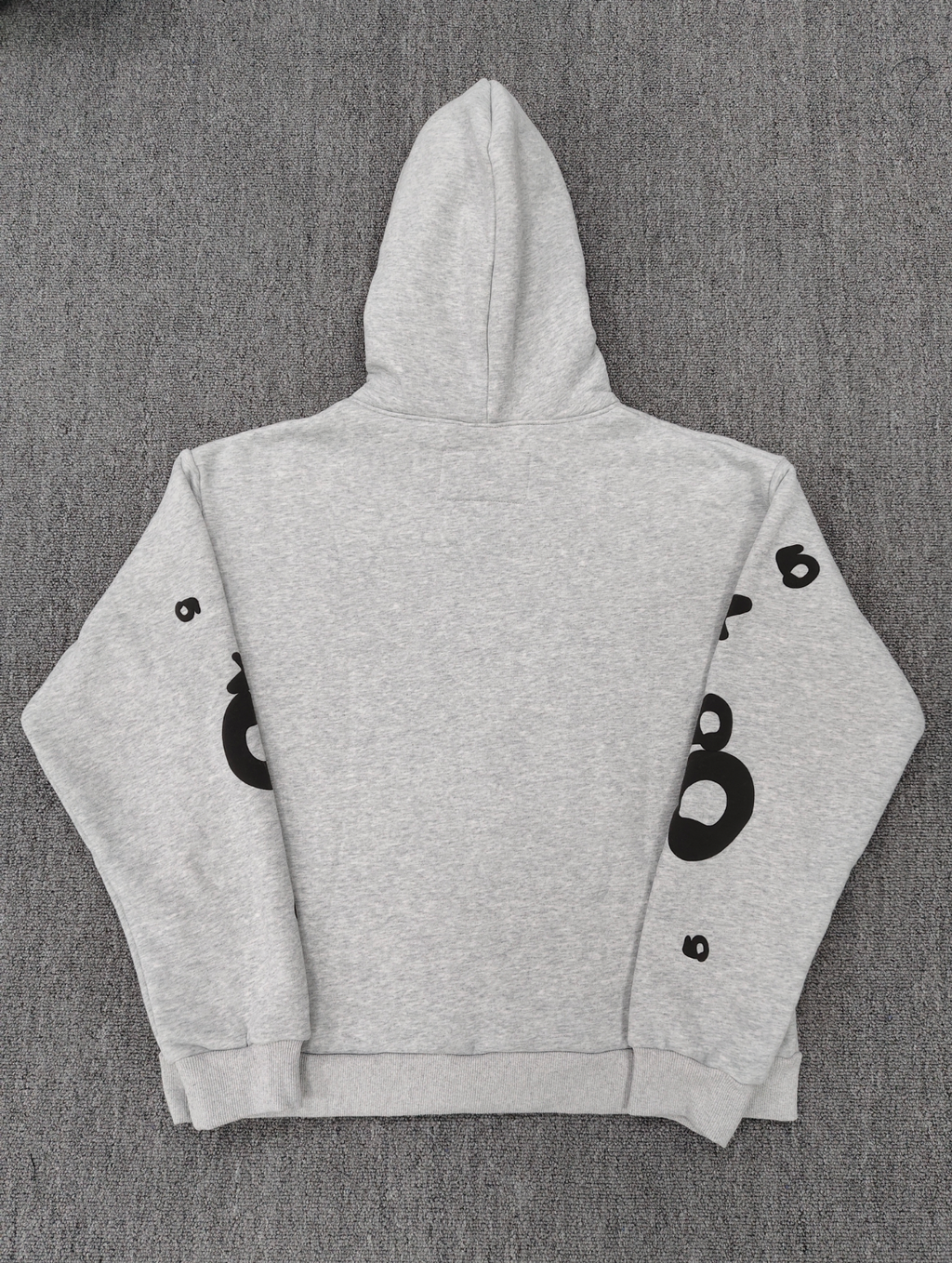 Sp5der Worldwide Beluga hoodie features a distinctive black star graphic across the chest on a light grey heather fabric