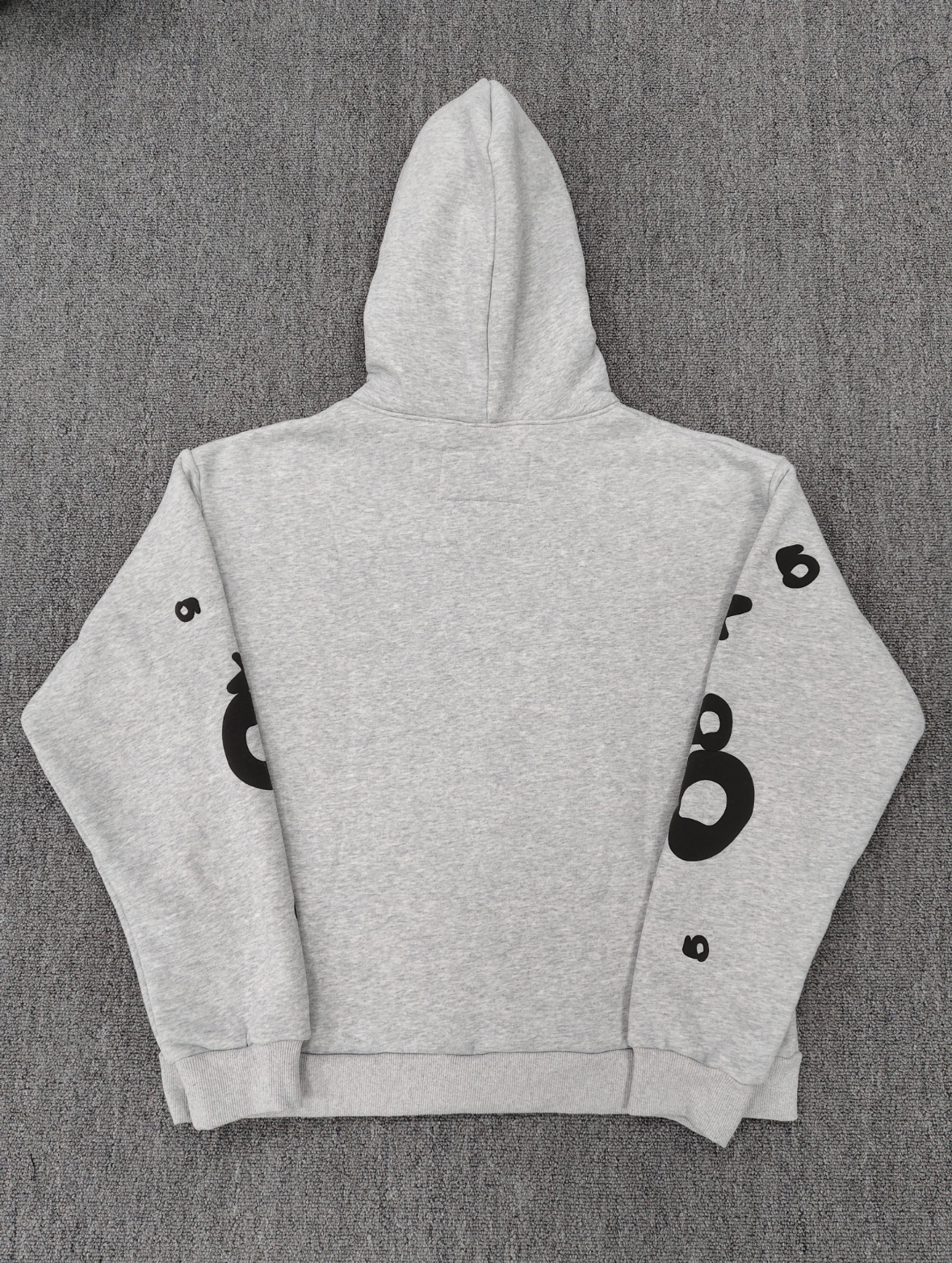 Sp5der Worldwide Beluga hoodie features a distinctive black star graphic across the chest on a light grey heather fabric
