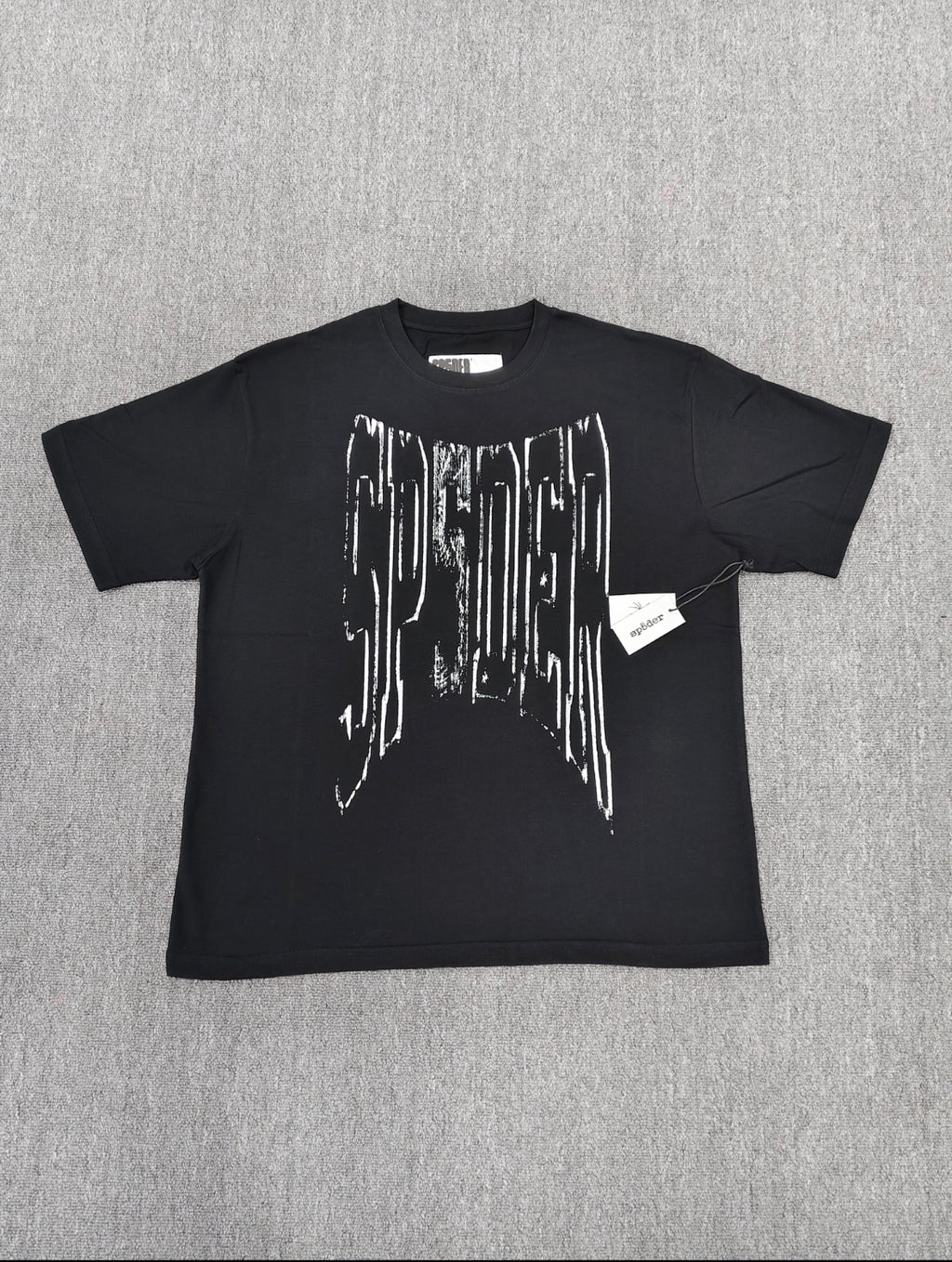 a black SP5DER Diffused Collegiate T-shirt featuring a large white, distressed graphic logo