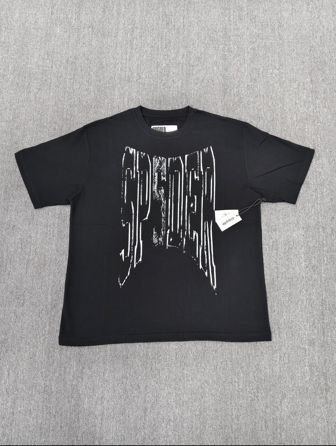 a black SP5DER Diffused Collegiate T-shirt featuring a large white, distressed graphic logo