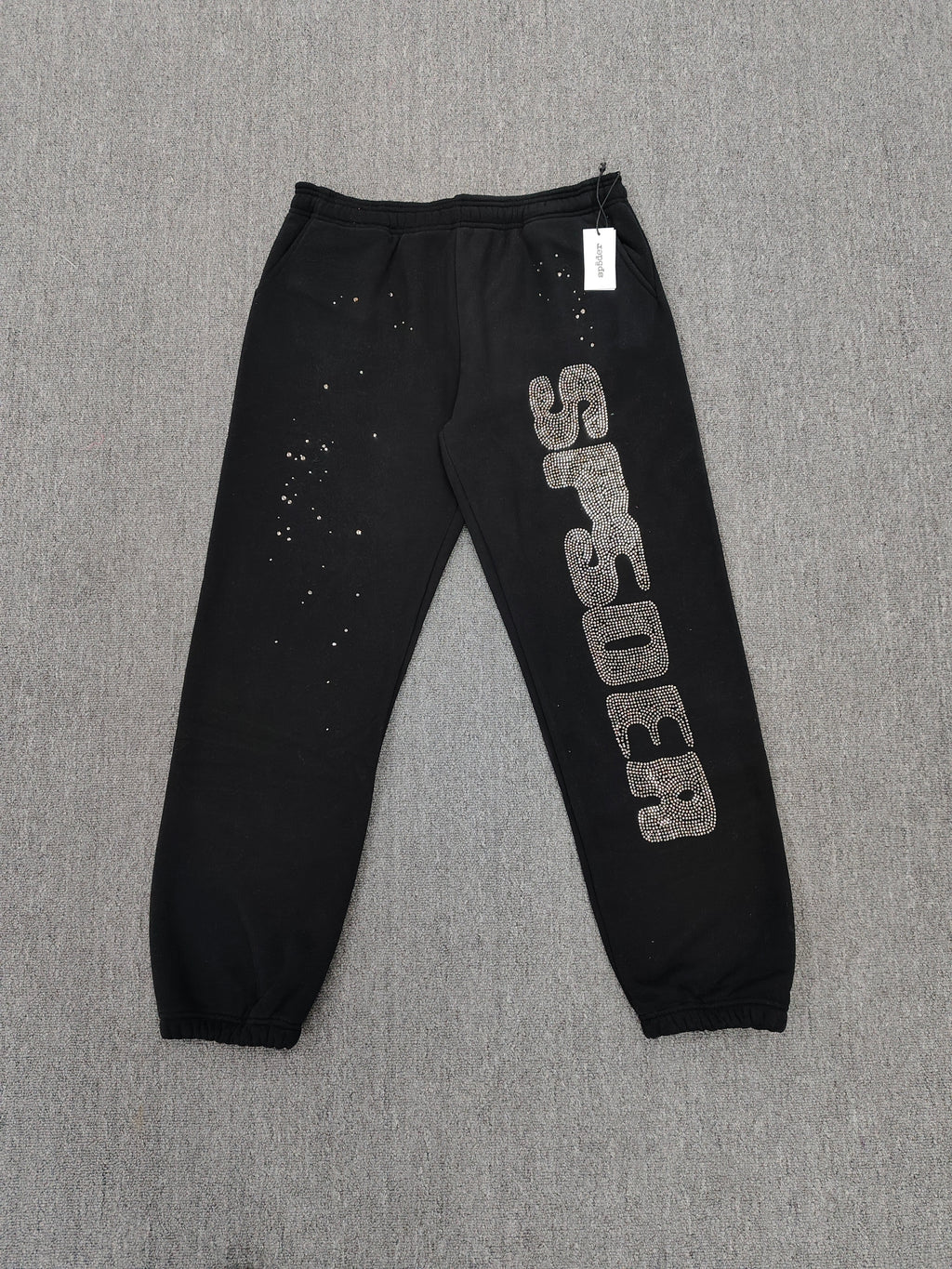 Sp5der Rhinestone Silk sweatpants in black featuring a large rhinestone-embellished logo and scattered star details
