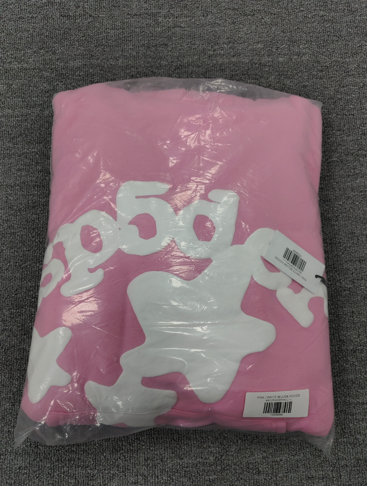Sp5der pink graphic pullover hoodie features a prominent white screen-printed spiderweb design on the front
