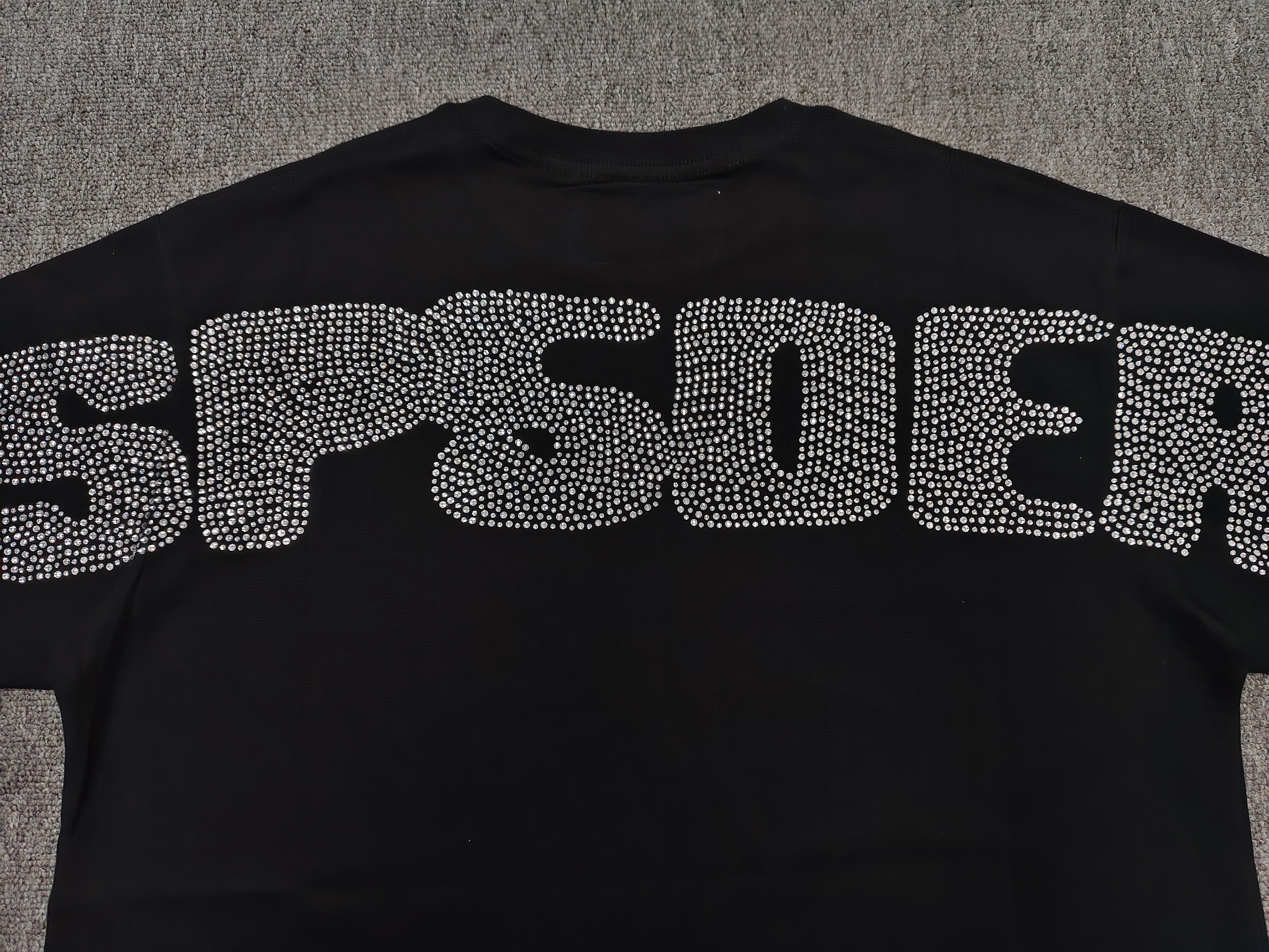 black Sp5der Rhinestone Silk Tee features a prominent crystal-embellished spider web graphic on the chest