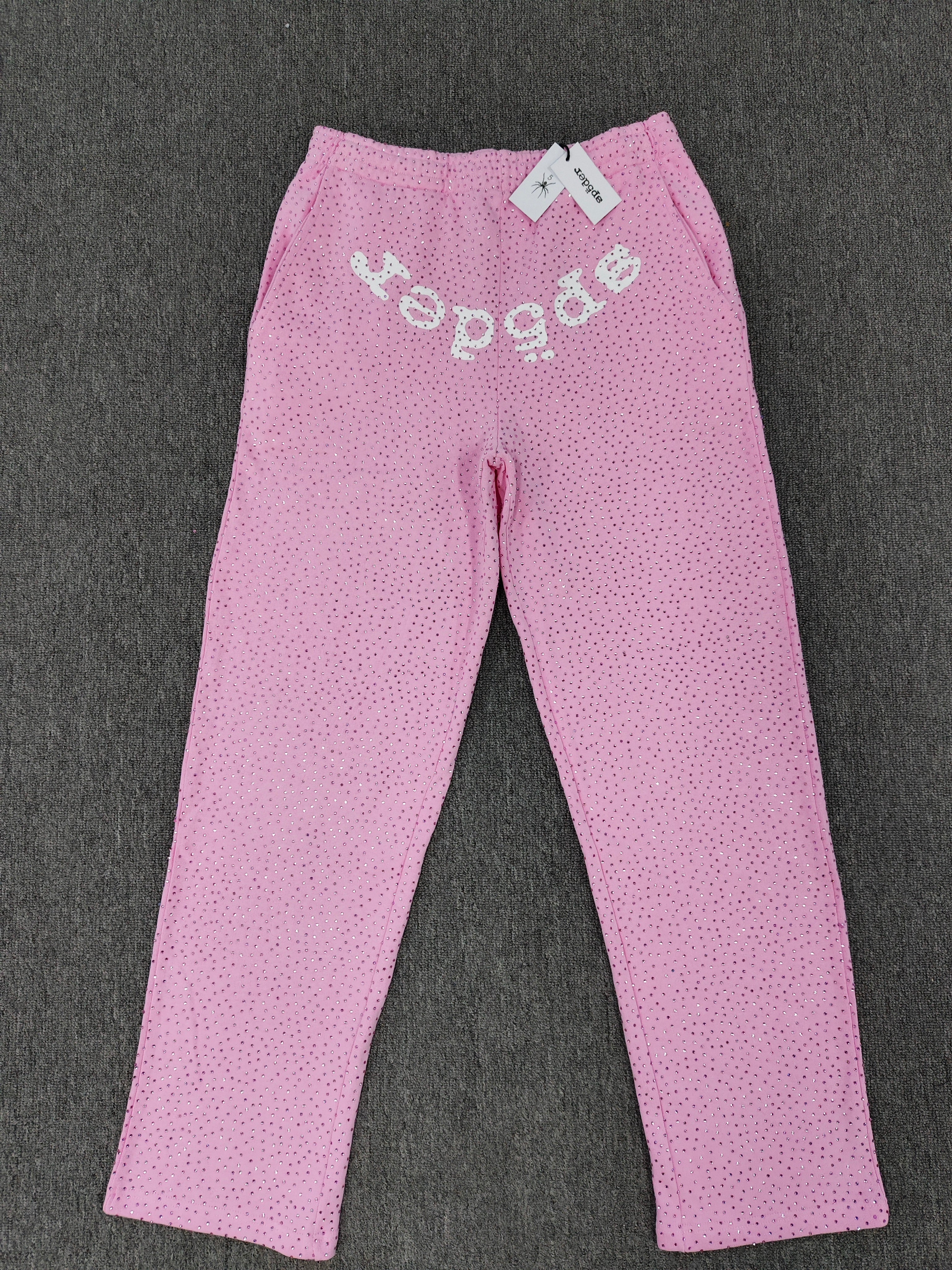 pink Sp5der sweatpants feature an all-over tonal rhinestone application and a SP5DER logo printed across the crotch