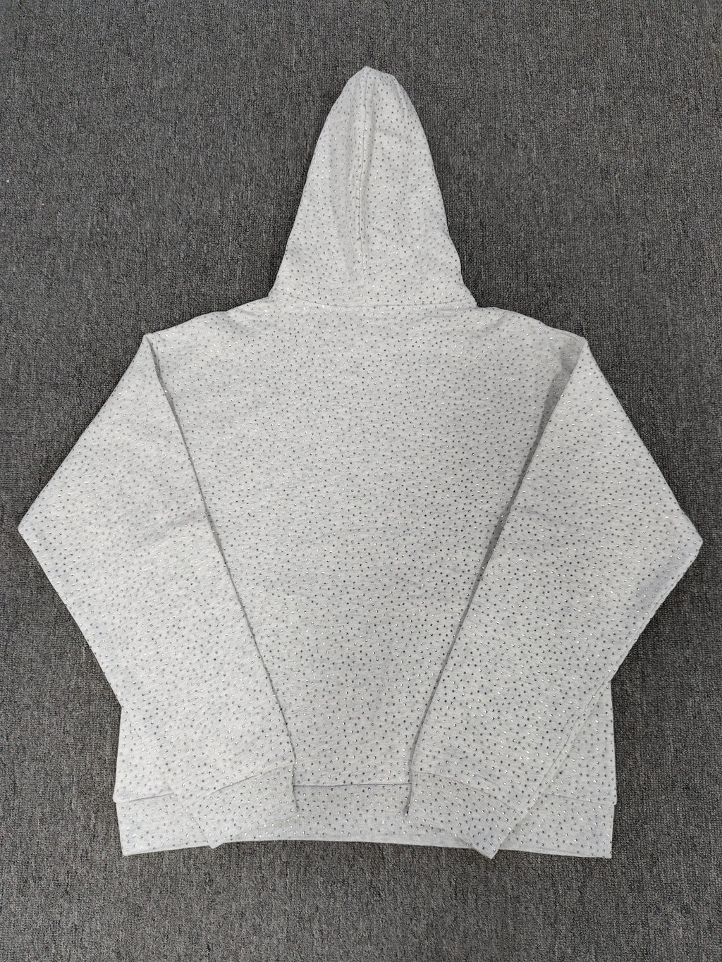 a Sp5der VVS Hoodie in Heather Grey, recognized by its all-over tonal rhinestones and arch logo