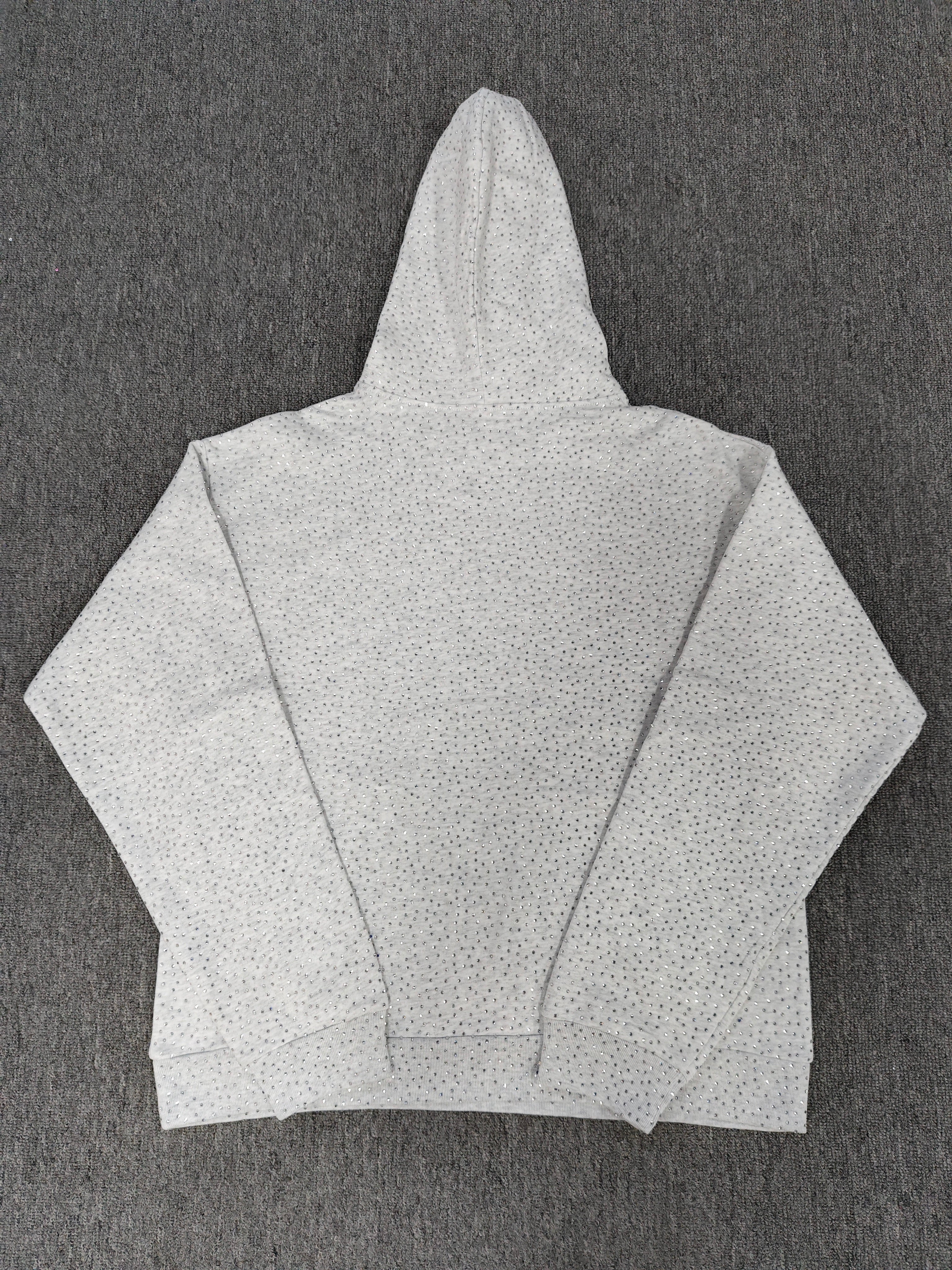 a Sp5der VVS Hoodie in Heather Grey, recognized by its all-over tonal rhinestones and arch logo
