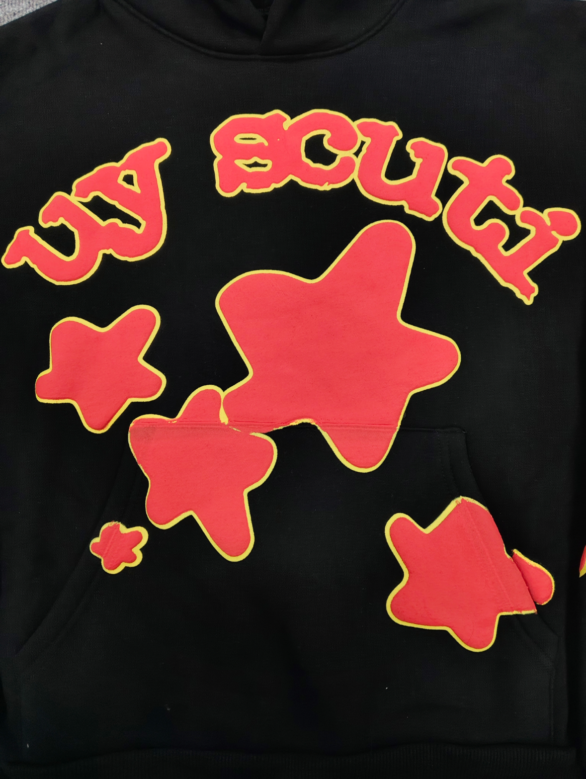 Sp5der x UY SCUTI Hoodie in black features prominent red star graphics