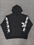 a black Sp5der Stone Hoodie featuring rhinestone embellishments along the sleeves