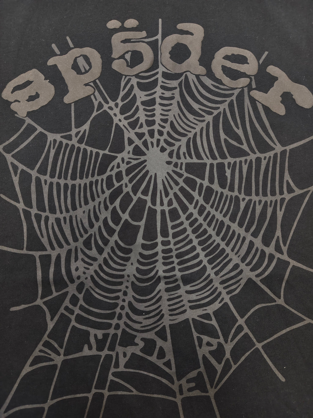 Sp5der Phantom OG Web Tee in black features a large gray spiderweb graphic on the chest
