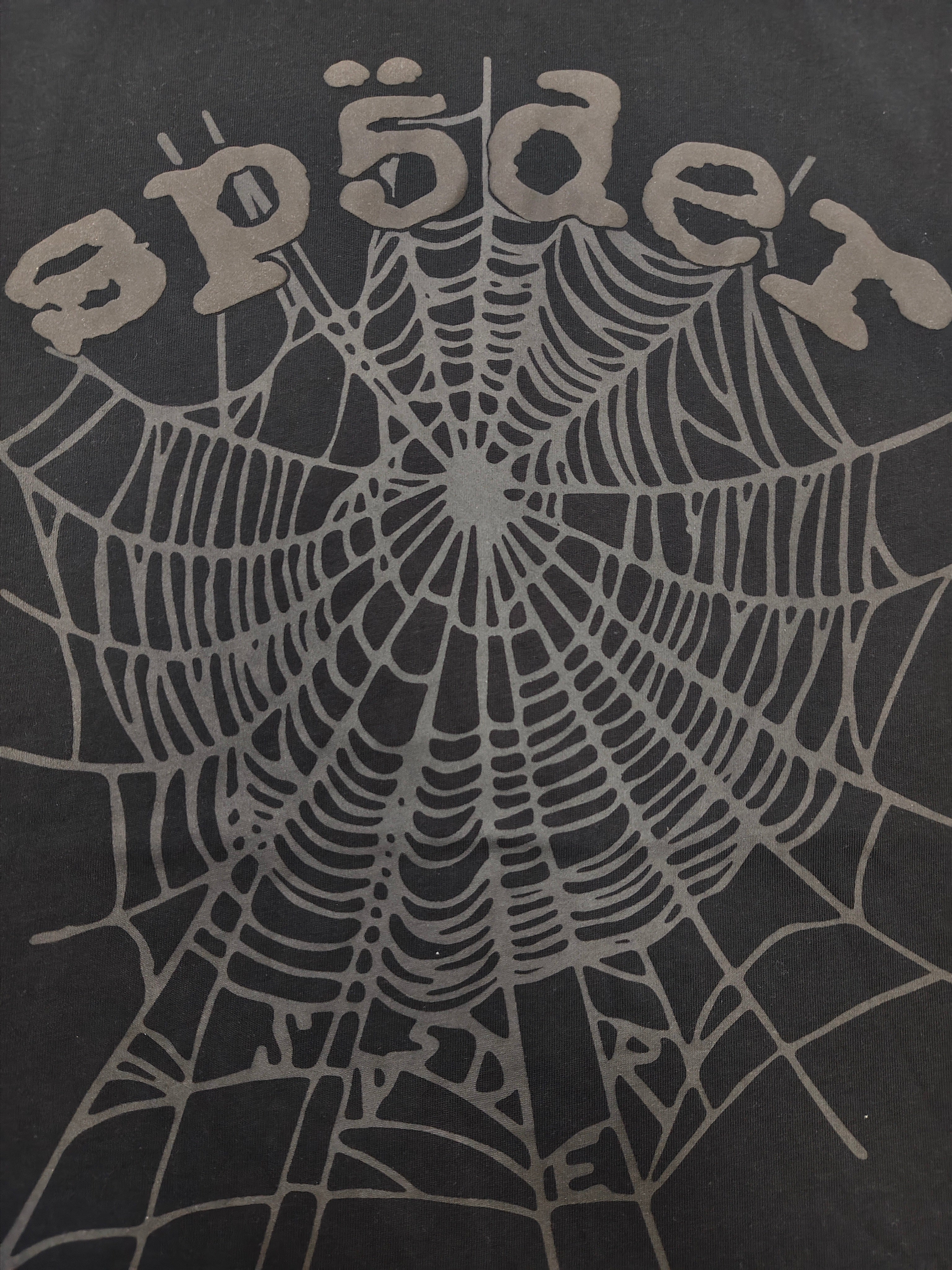 Sp5der Phantom OG Web Tee in black features a large gray spiderweb graphic on the chest