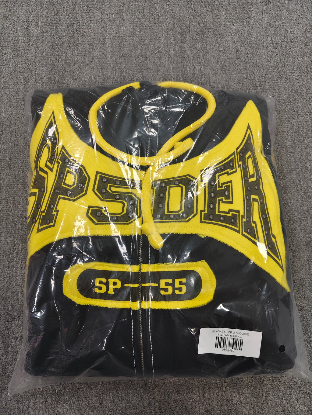 a Sp5der T&F Zip Hoodie in black and yellow with contrast stitching