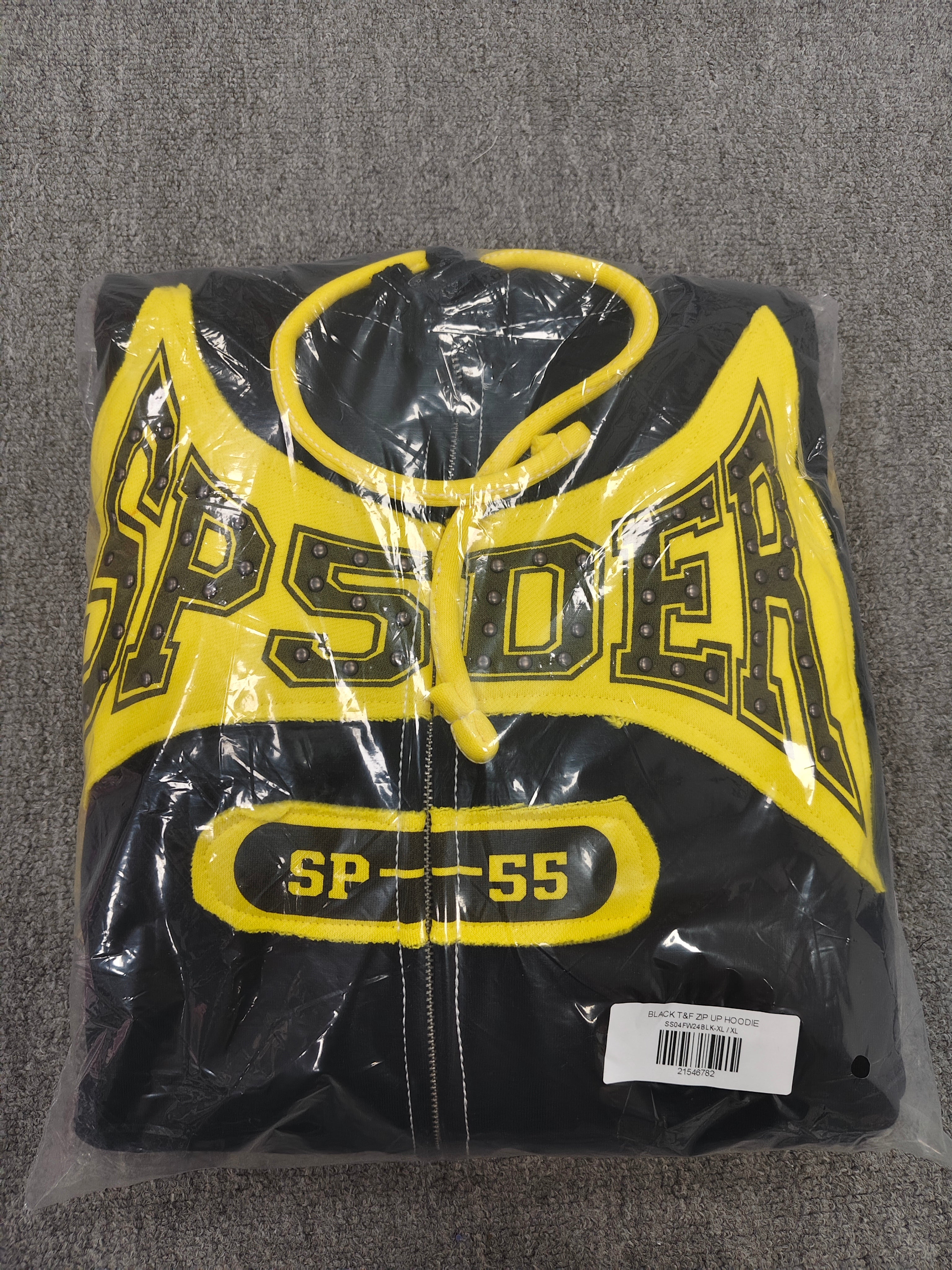 a Sp5der T&F Zip Hoodie in black and yellow with contrast stitching