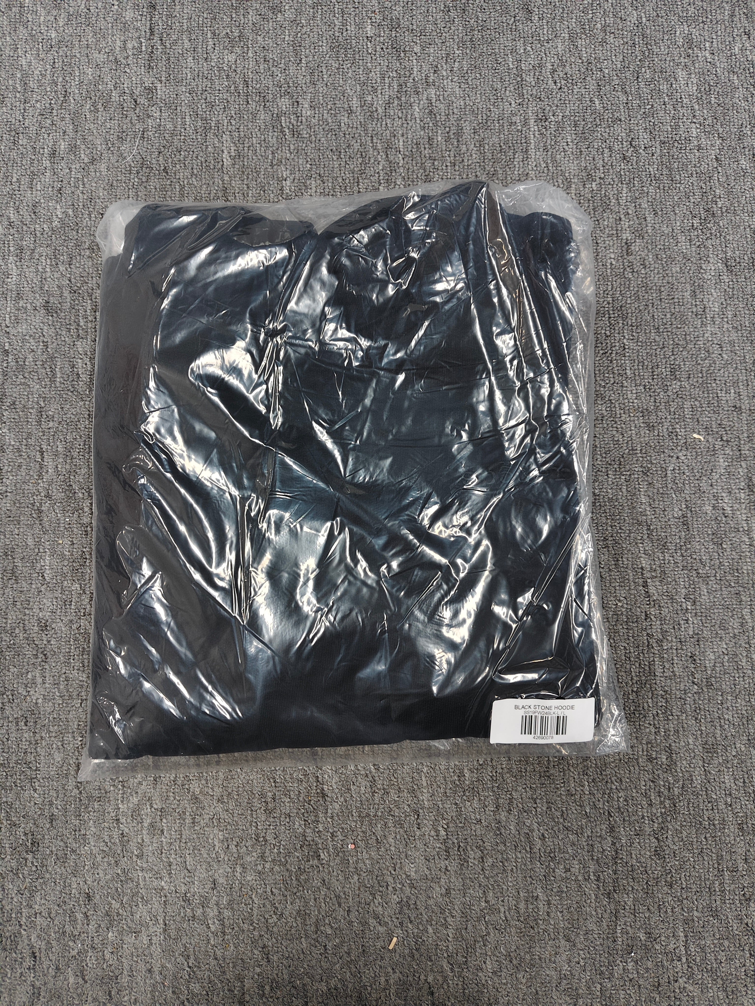 a black Sp5der Stone Hoodie featuring rhinestone embellishments along the sleeves