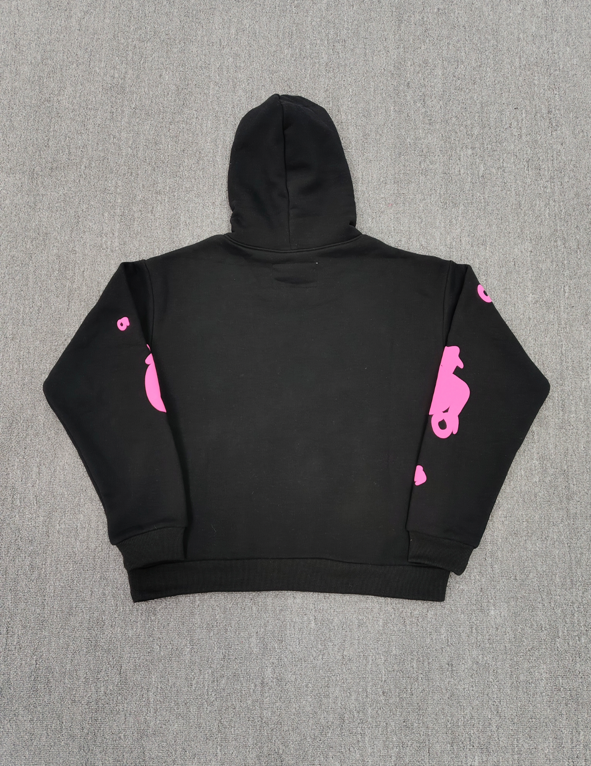 Sp5der Beluga Angel Number Hoodie in black featuring a prominent pink puff-print graphic on the chest