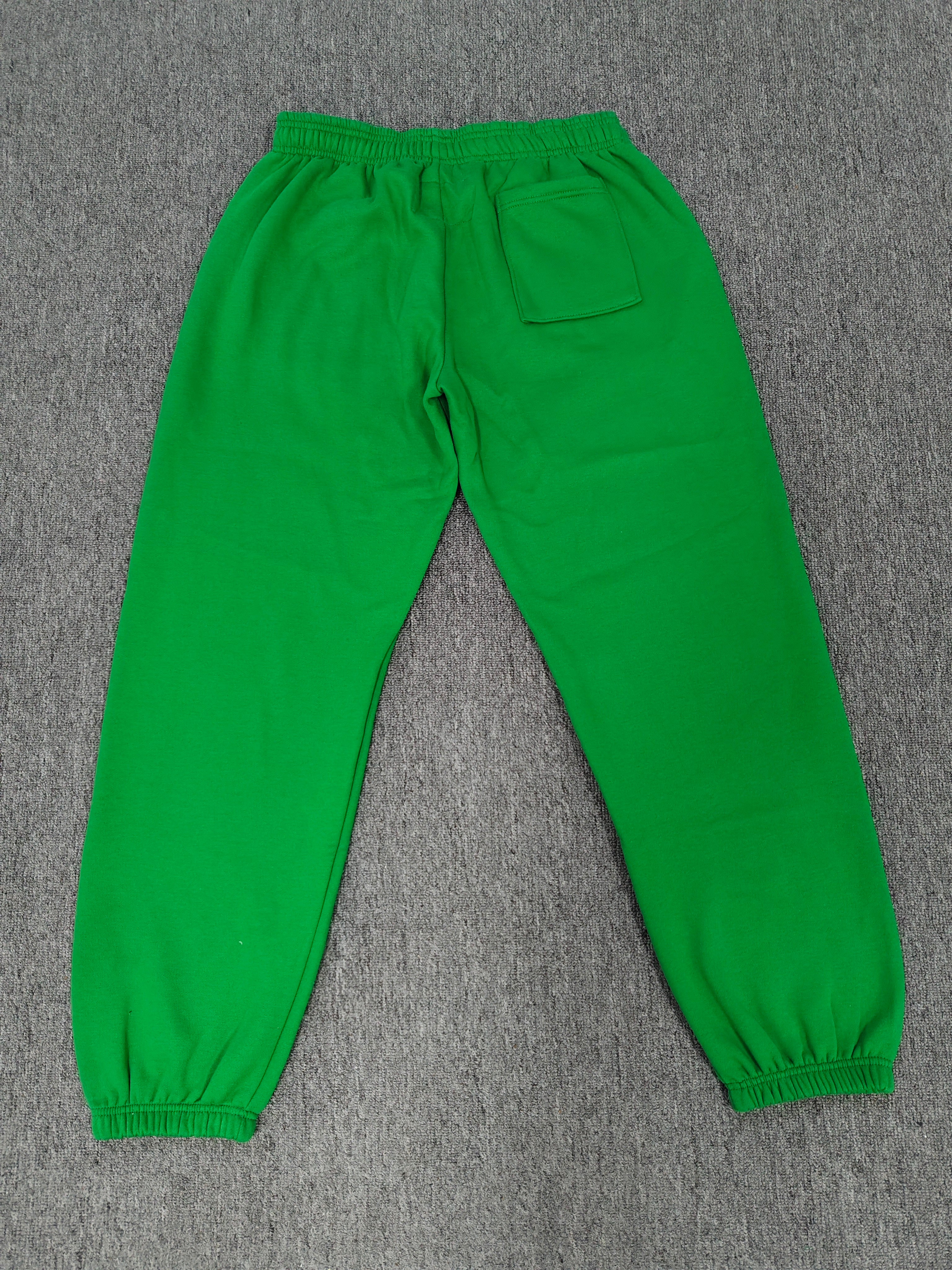 Sp5der Star OG Web V2 Sweatpants in the Slime Green colorway, featuring scattered yellow star motifs and a yellow brand graphic