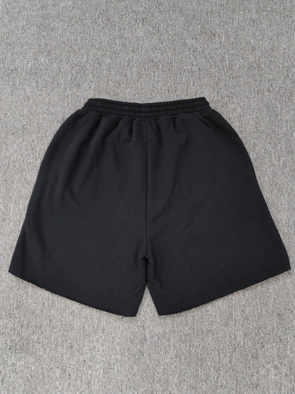 black Sp5der shorts feature a rhinestone-embellished logo and a spider web graphic