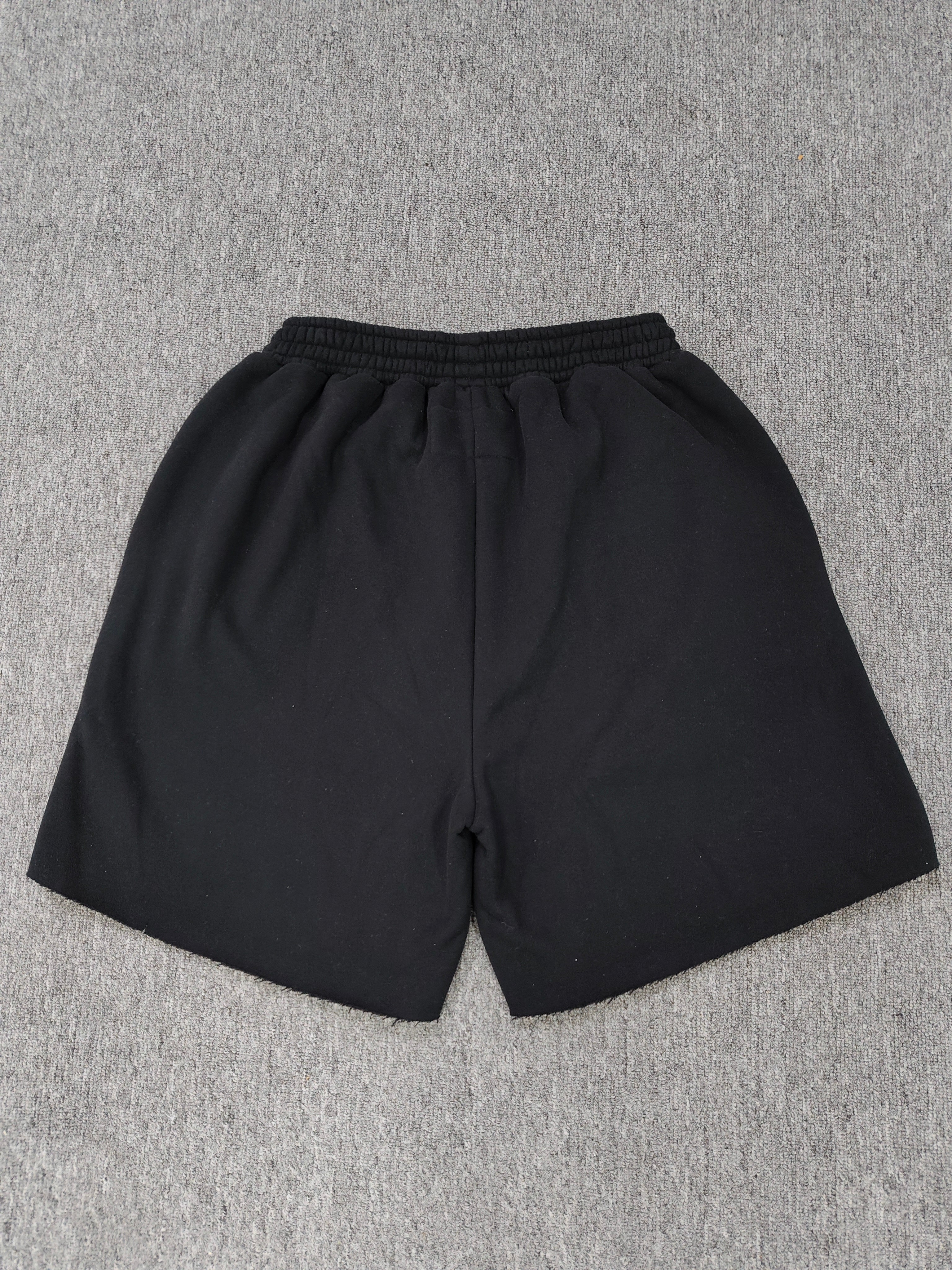 black Sp5der shorts feature a rhinestone-embellished logo and a spider web graphic