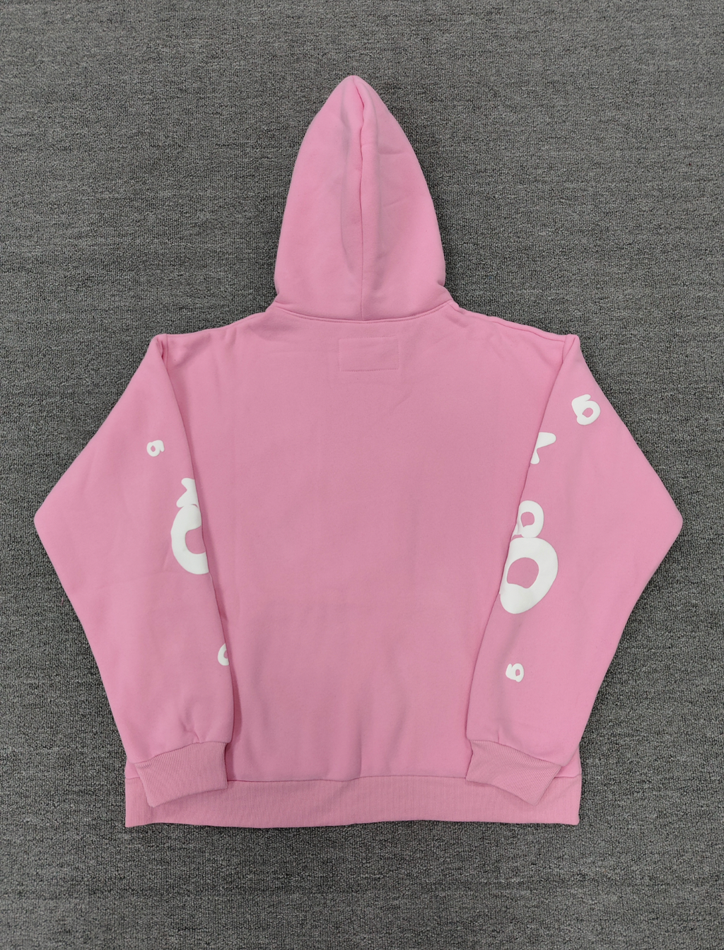 Sp5der pink graphic pullover hoodie features a prominent white screen-printed spiderweb design on the front