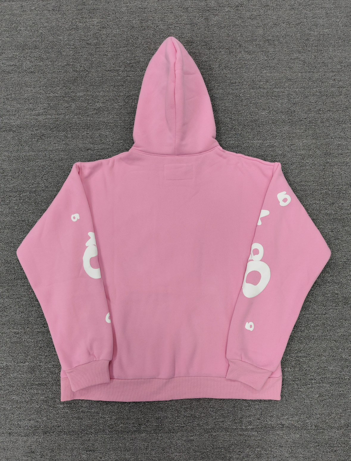 Sp5der pink graphic pullover hoodie features a prominent white screen-printed spiderweb design on the front