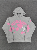 a grey Sp5der "Beluga" hoodie featuring pink star graphics and brand lettering