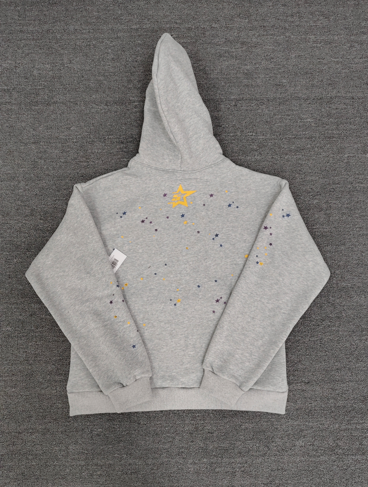 grey Sp5der hoodie features a prominent pink rhinestone graphic and a blue spiderweb design