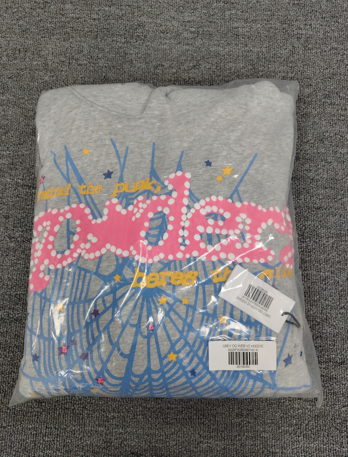 grey Sp5der hoodie features a prominent pink rhinestone graphic and a blue spiderweb design