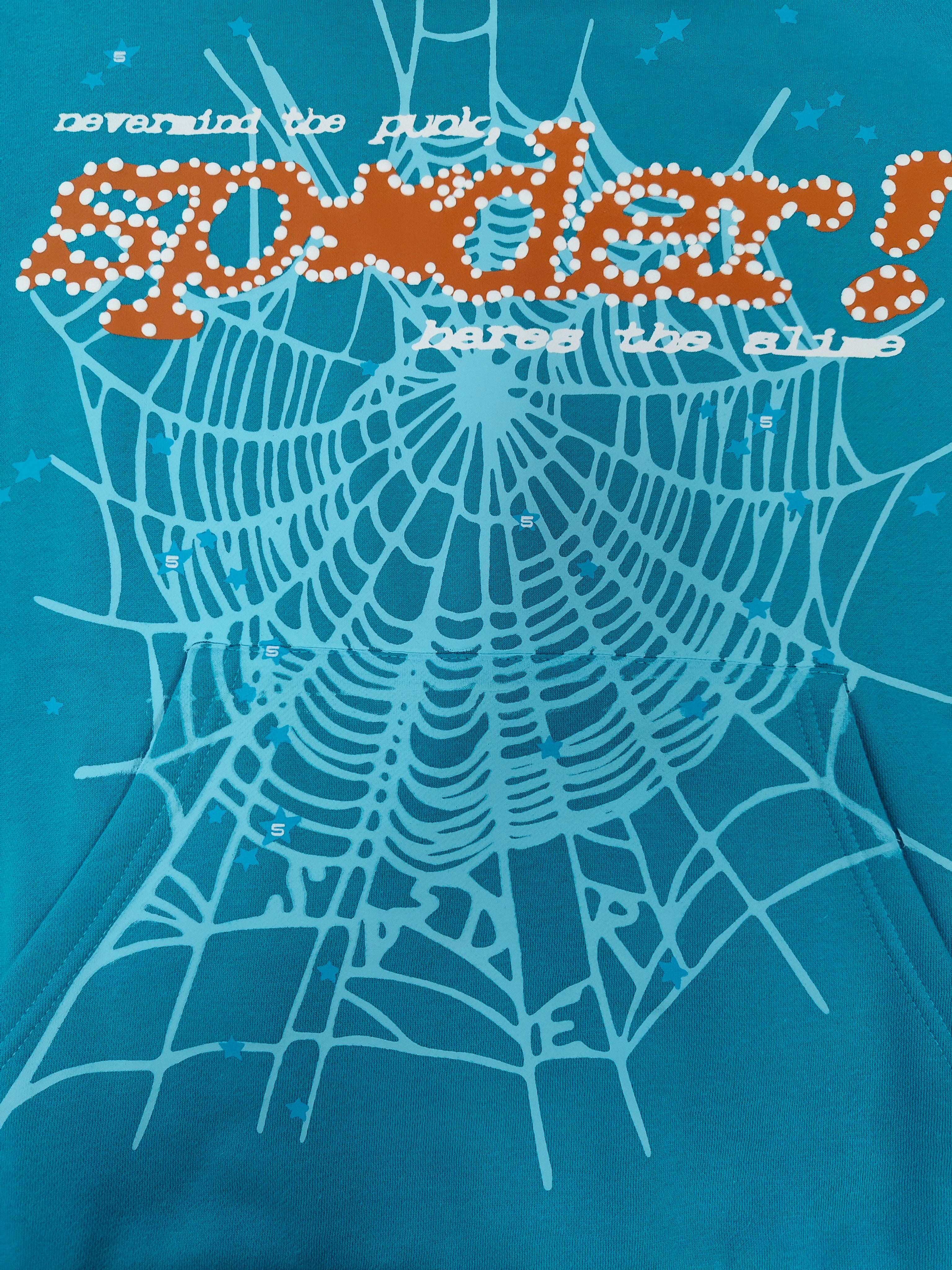 a Sp5der Punk V2 Hoodie in the Cyan colorway, featuring a prominent rhinestone graphic and spider web motif