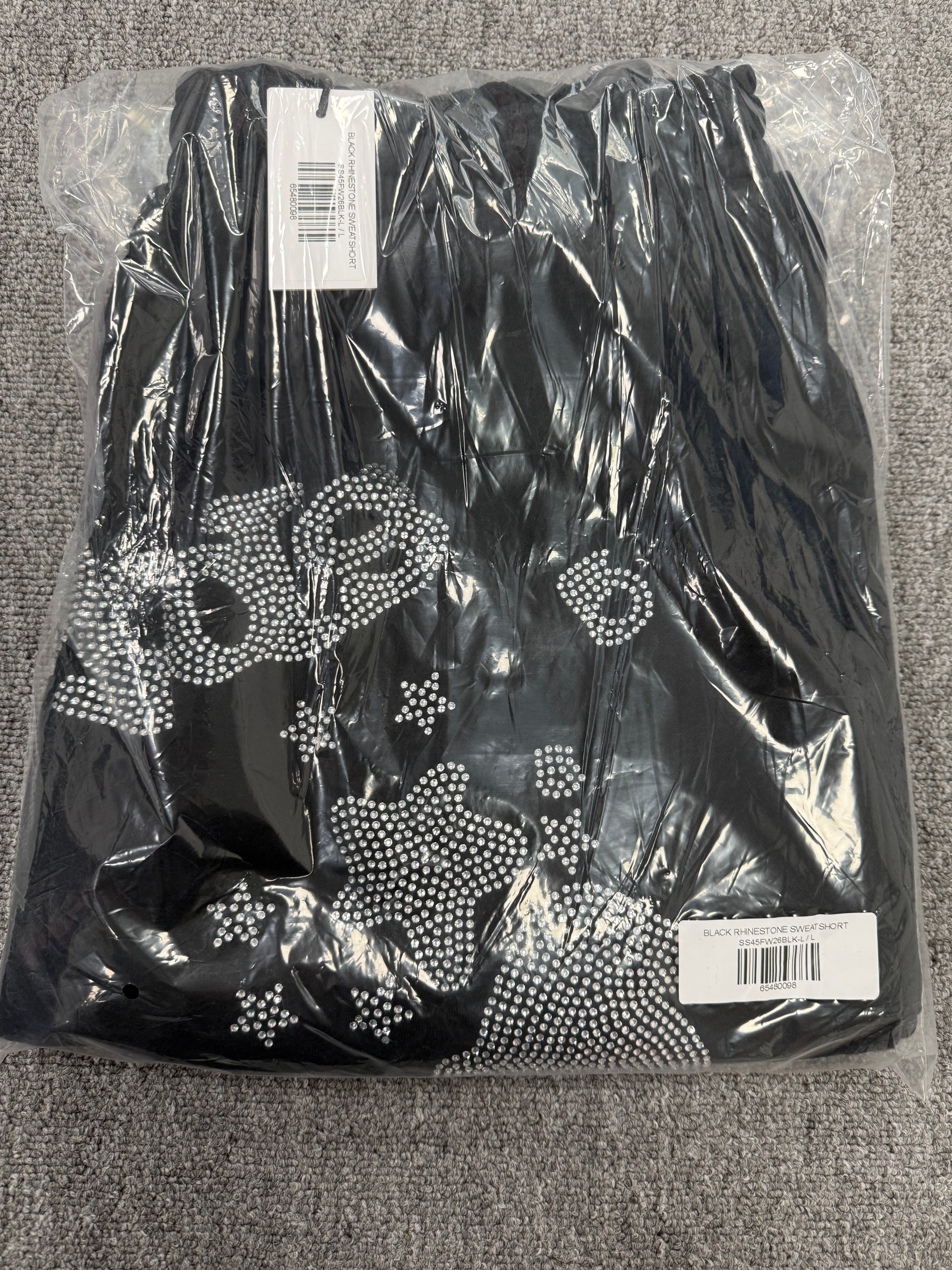Sp5der Black Rhinestone Letter Print Jogger Shorts featuring a distinctive rhinestone star graphic.