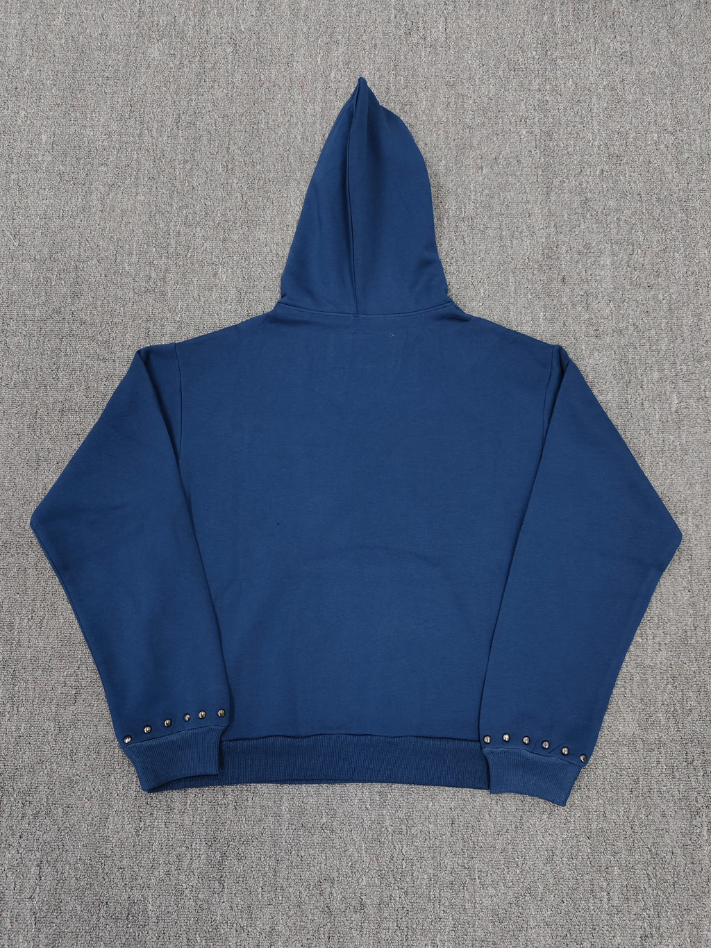 a blue Sp5der Punk V3 Studded Hoodie, featuring rhinestone-accented branding and silver stud details along the hood, logo, and pocket