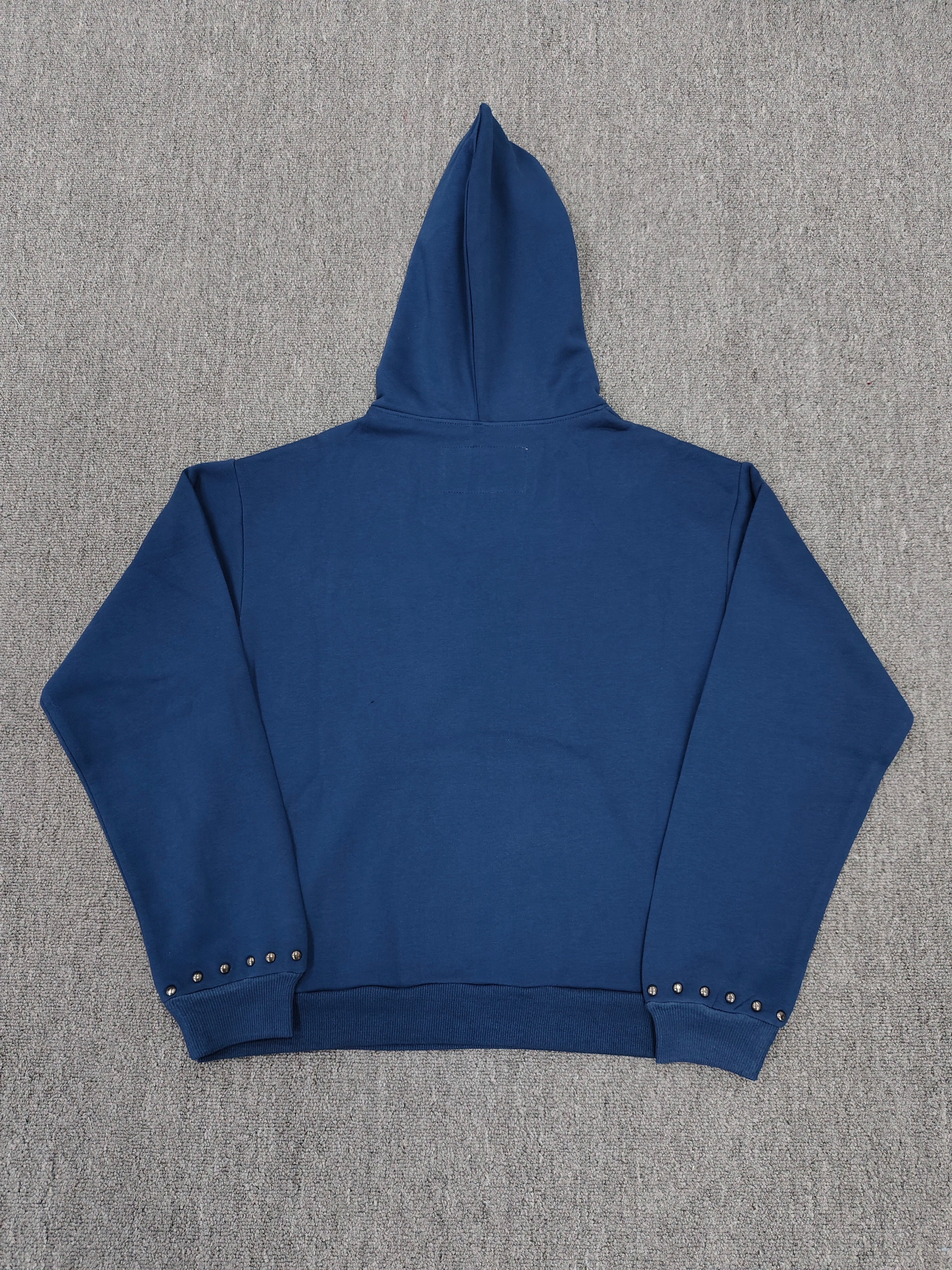 a blue Sp5der Punk V3 Studded Hoodie, featuring rhinestone-accented branding and silver stud details along the hood, logo, and pocket