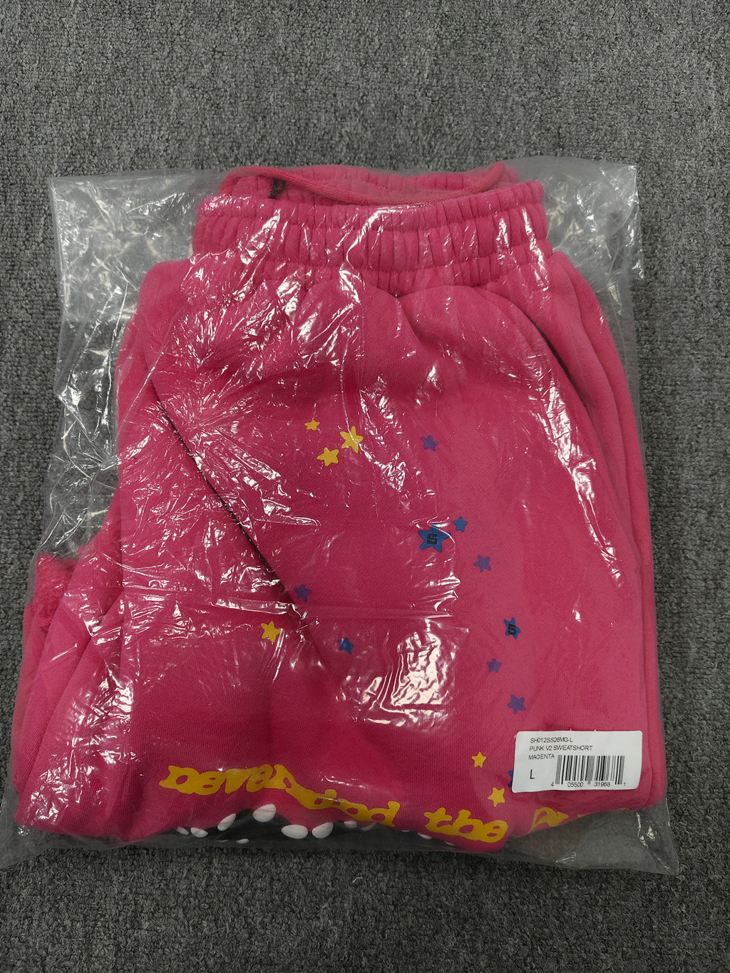 pink shorts Sp5der "Punk V2" collection, featuring rhinestone branding and scattered star graphics
