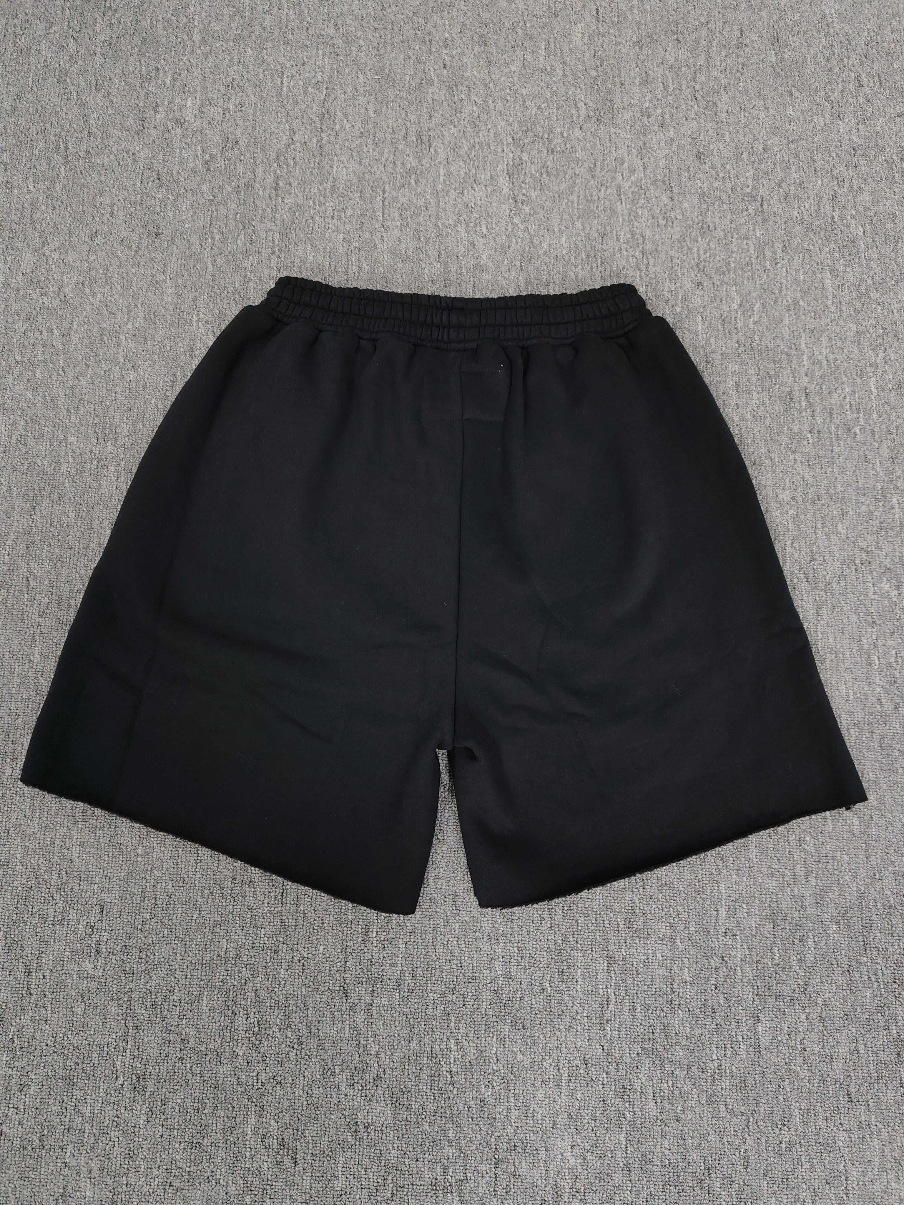 Sp5der Beluga Outline Sweatshorts in black, featuring prominent red-outlined graphic logos and stars